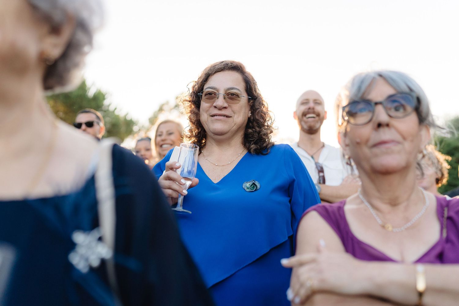 Wedding guests enjoying themselves at an outdoor celebration.