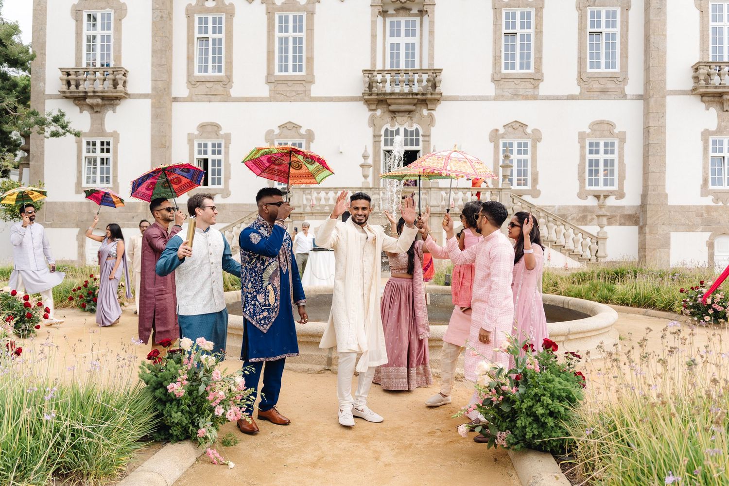 Outdoor wedding venue with classic architecture featuring white walls and ornate windows.