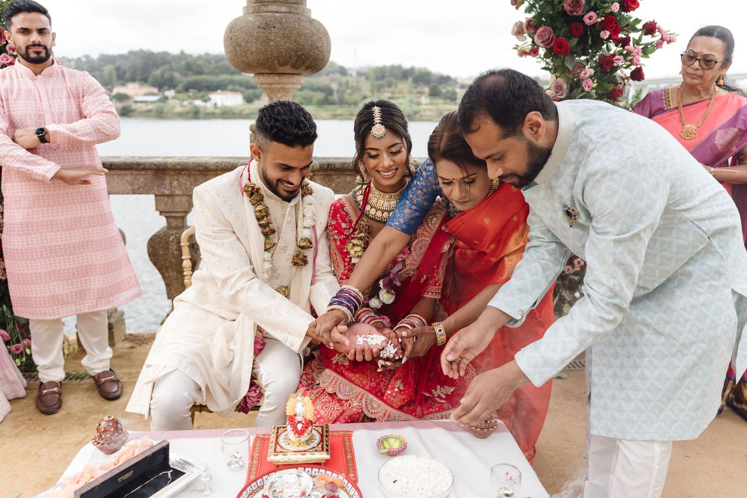 Wedding celebration moments captured at an outdoor venue with guests participating in traditional ceremonies.