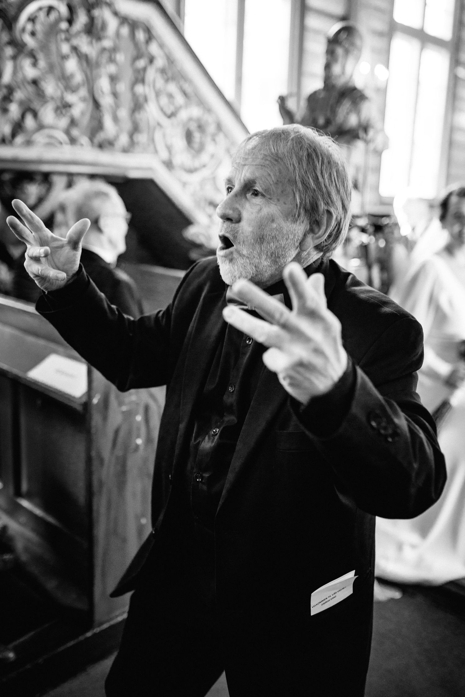 Black and white photo series showing animated gestures and expressions during a lively performance.