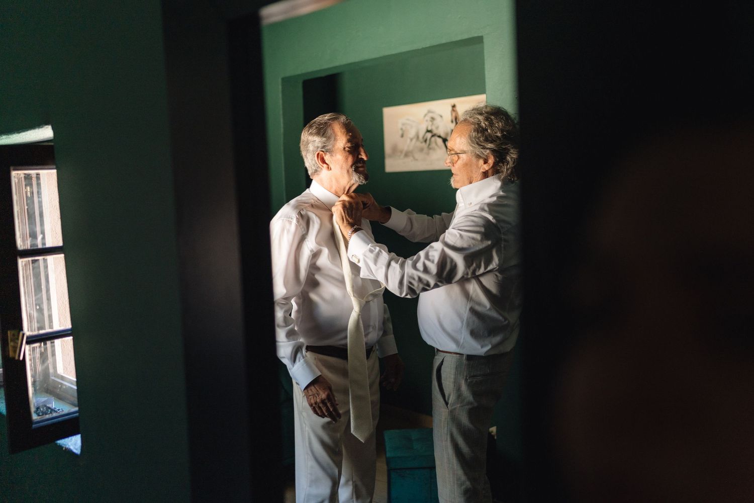 Atmospheric photos of interactions in a dimly lit room with green walls.