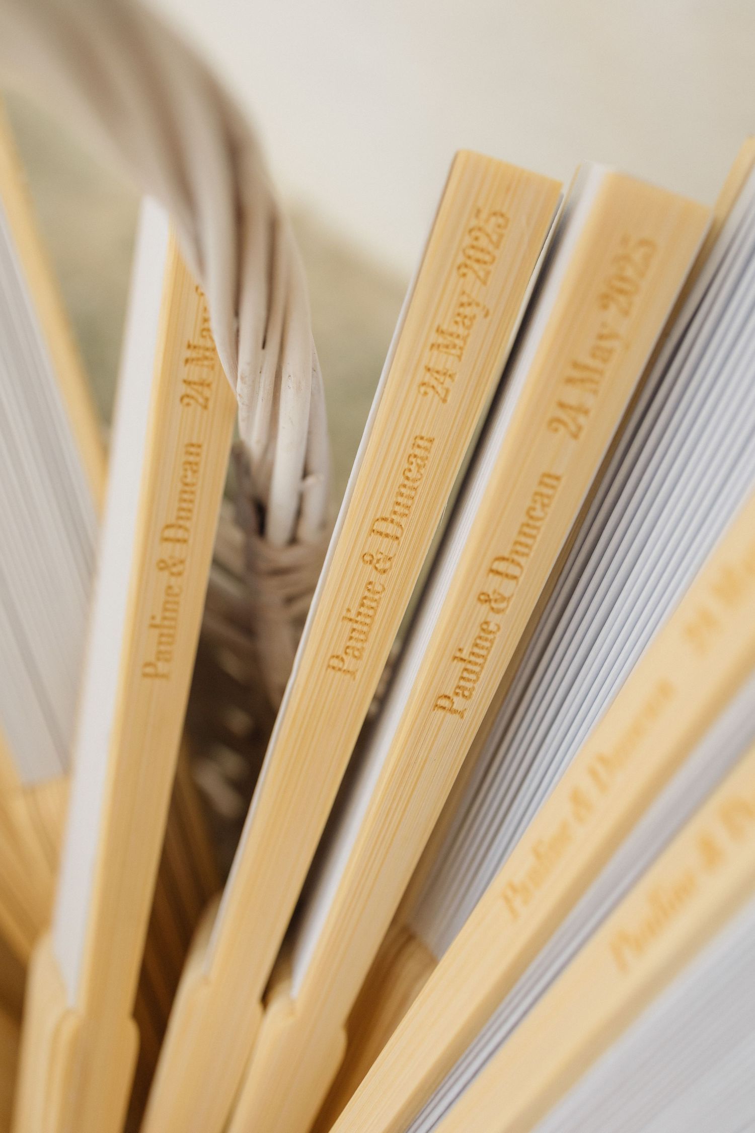 Close-up of wooden wedding program fans arranged together.