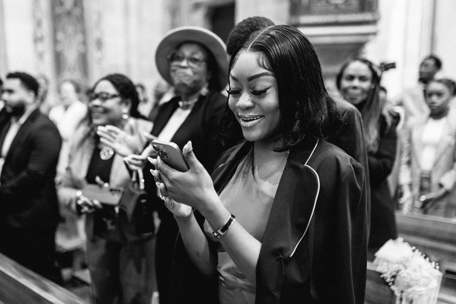 Black and white photos showing a crowd of wedding guests celebrating and dancing at a reception.