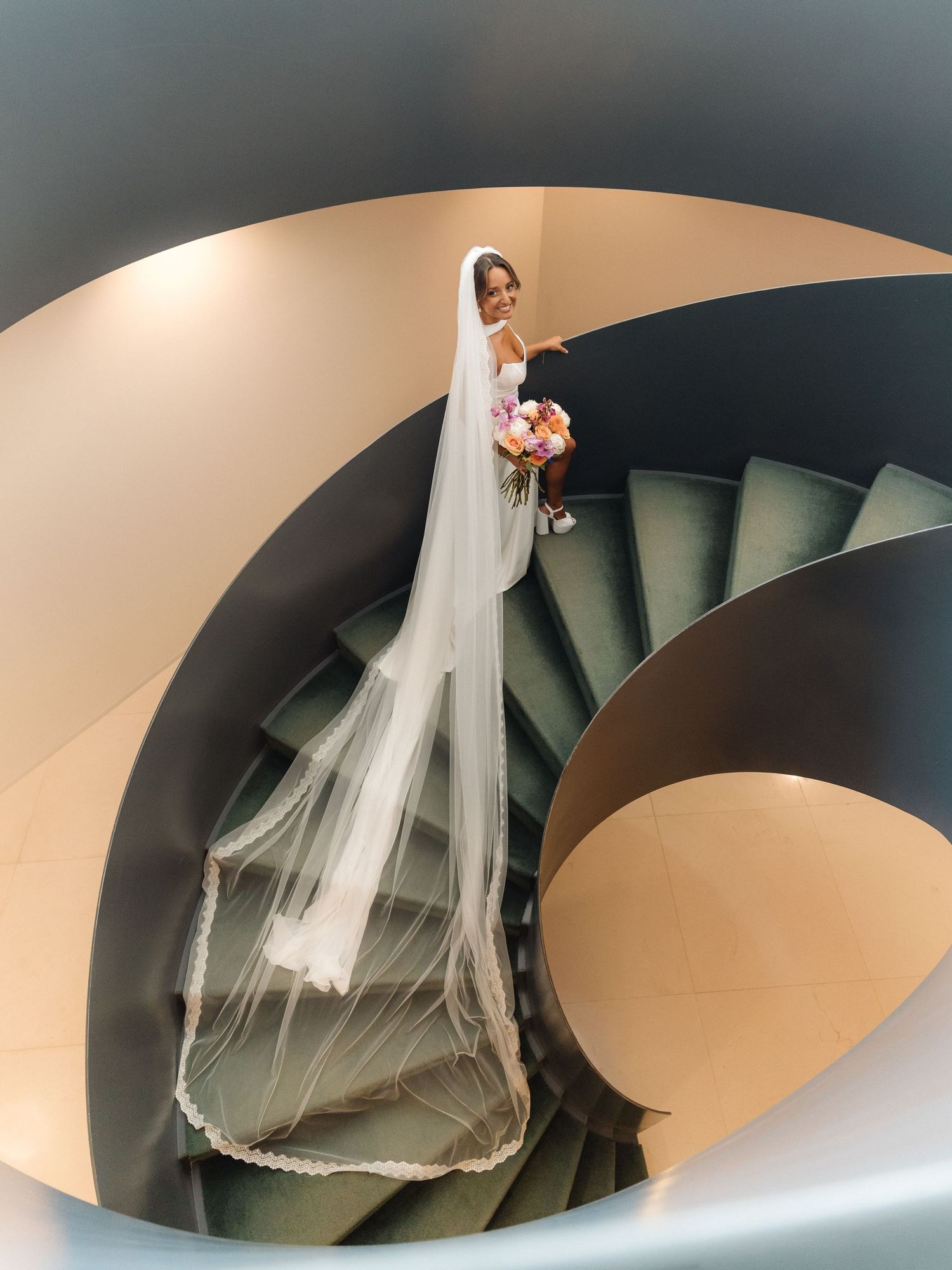 Artistic wedding photography sequence showing flowing white dress and veil on curved modern staircase.