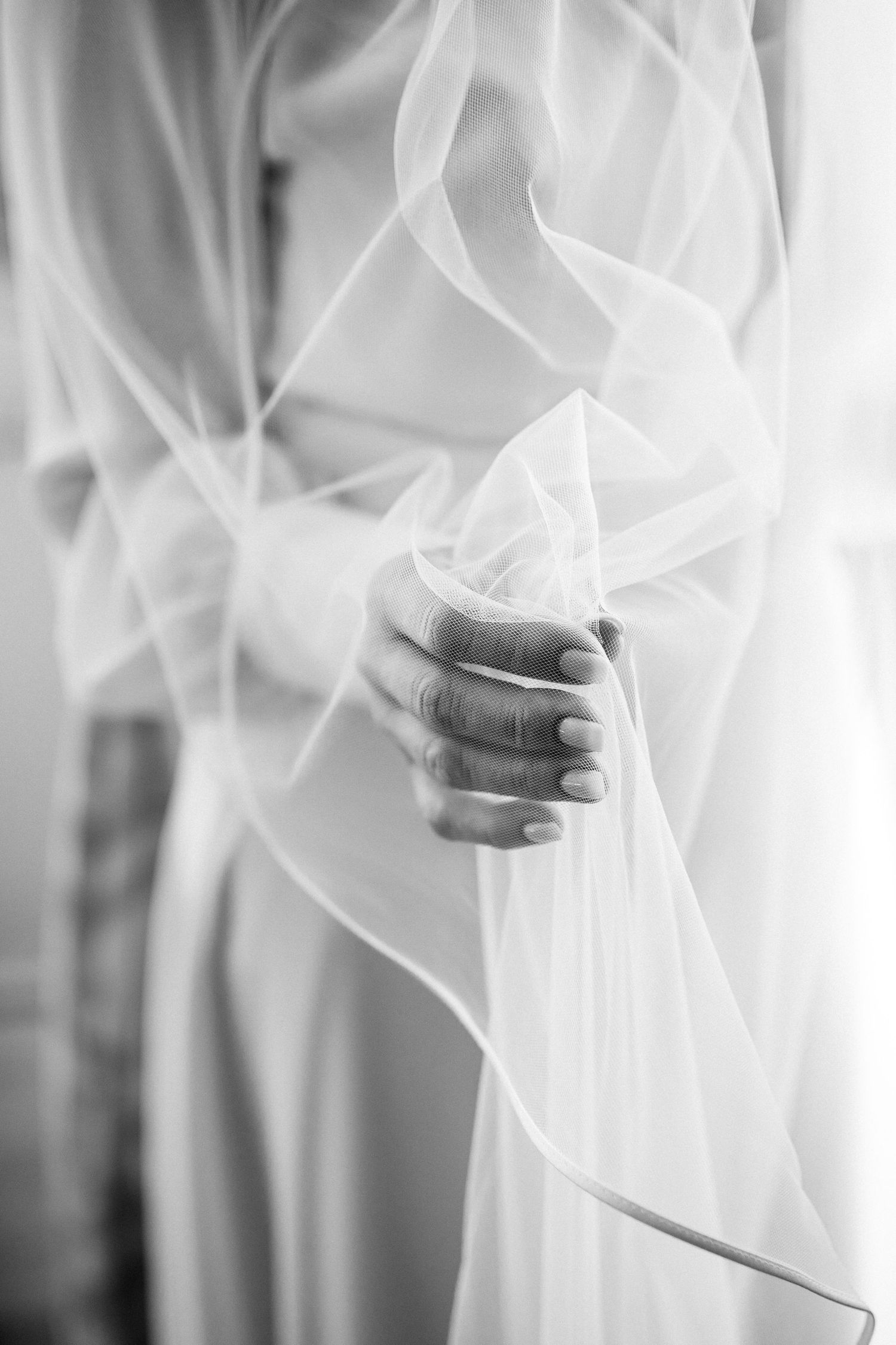 Close-up shot of delicate white tulle fabric creating an ethereal bridal veil texture.