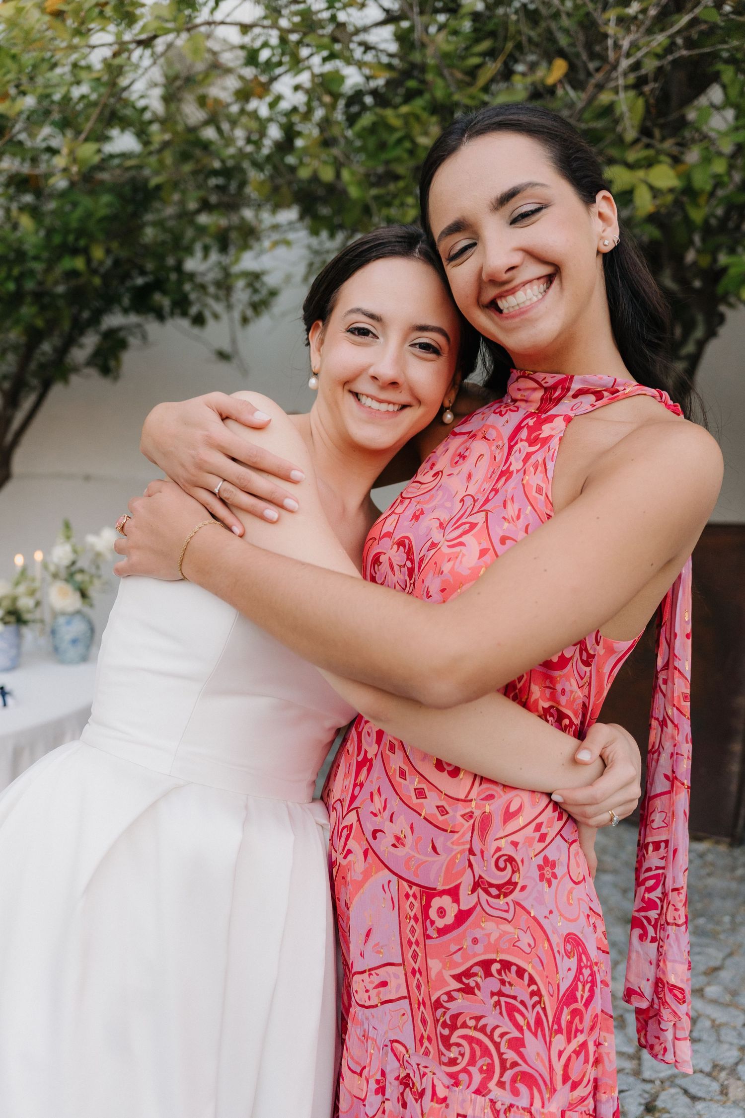 Two people embracing and smiling during a celebratory outdoor event.