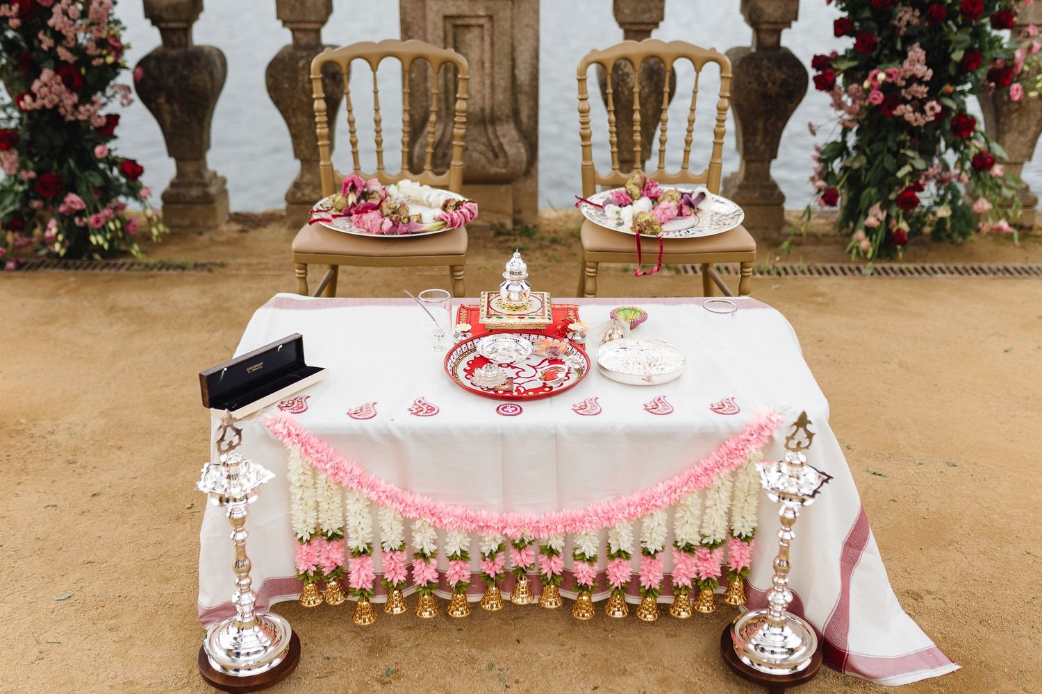 Elegant wedding ceremony setup with floral arrangements and decorative arches.