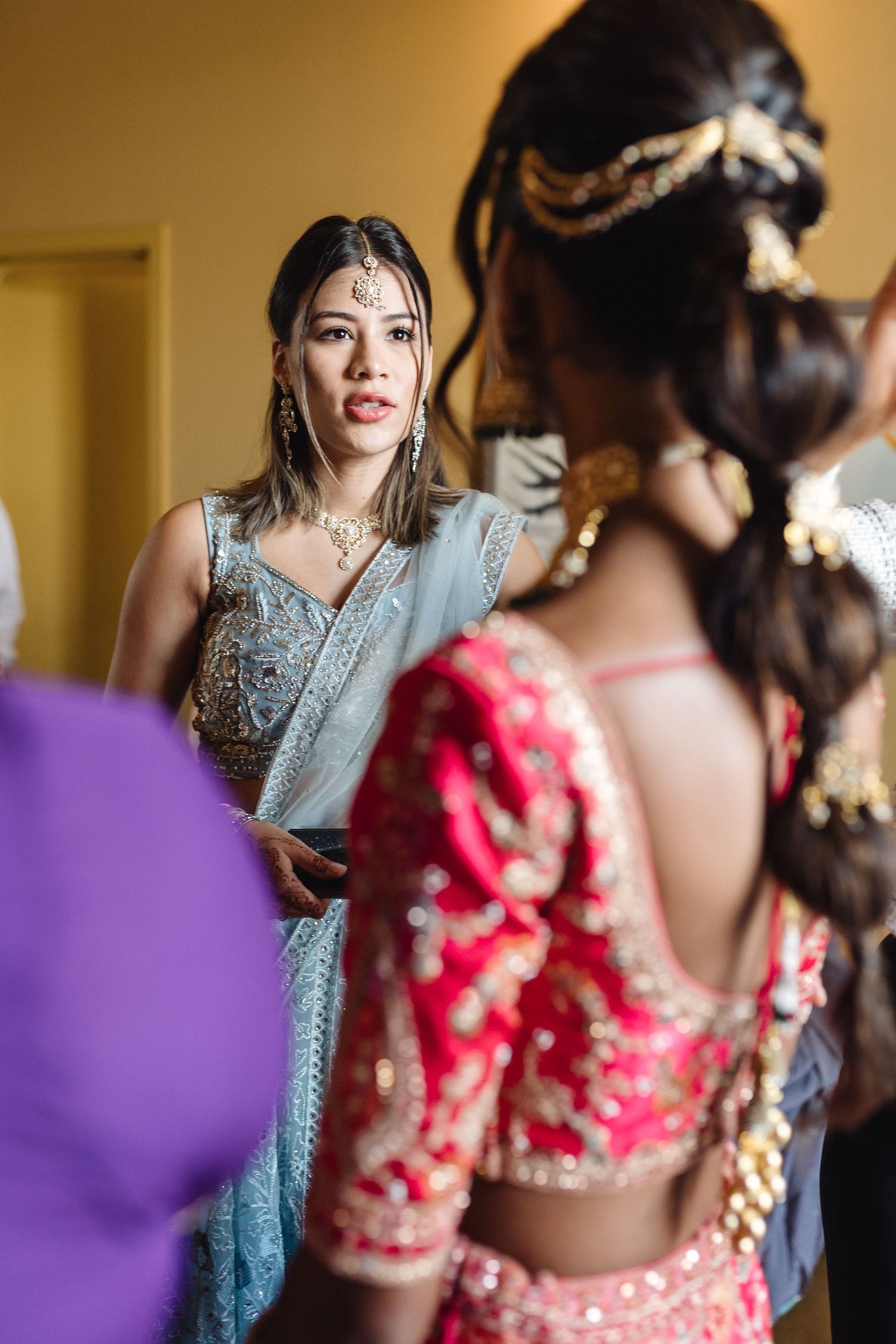 Wedding preparations showing traditional Indian attire with intricate embellishments and jewelry.