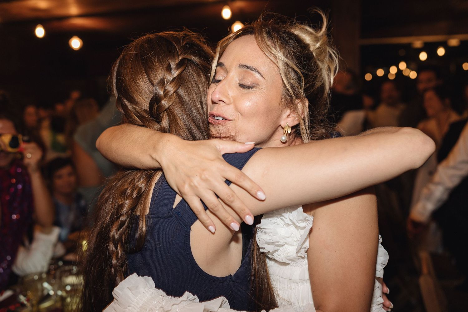 Emotional moments shared between guests during wedding reception dancing.