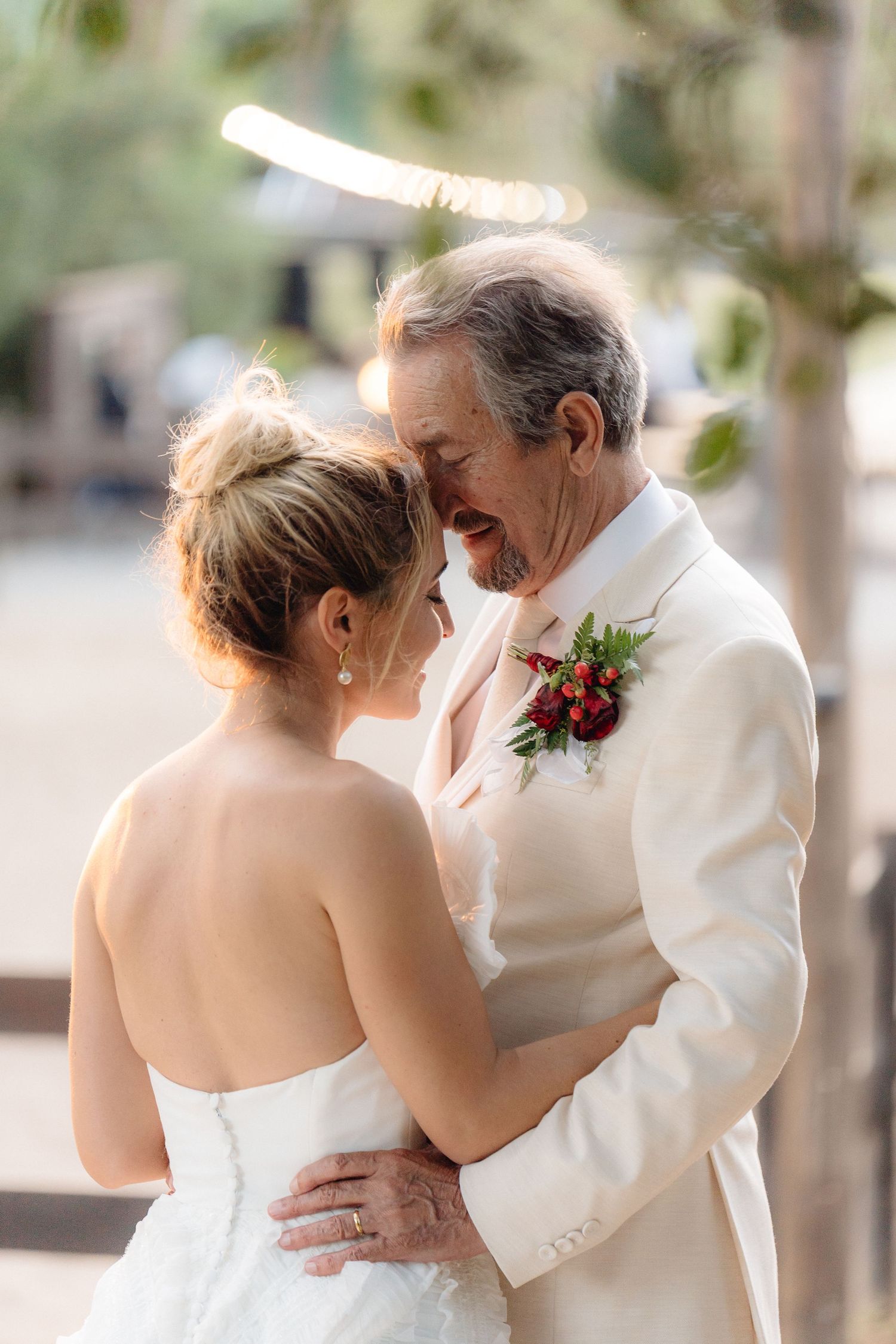 Romantic wedding portraits show tender embraces against a soft outdoor backdrop.