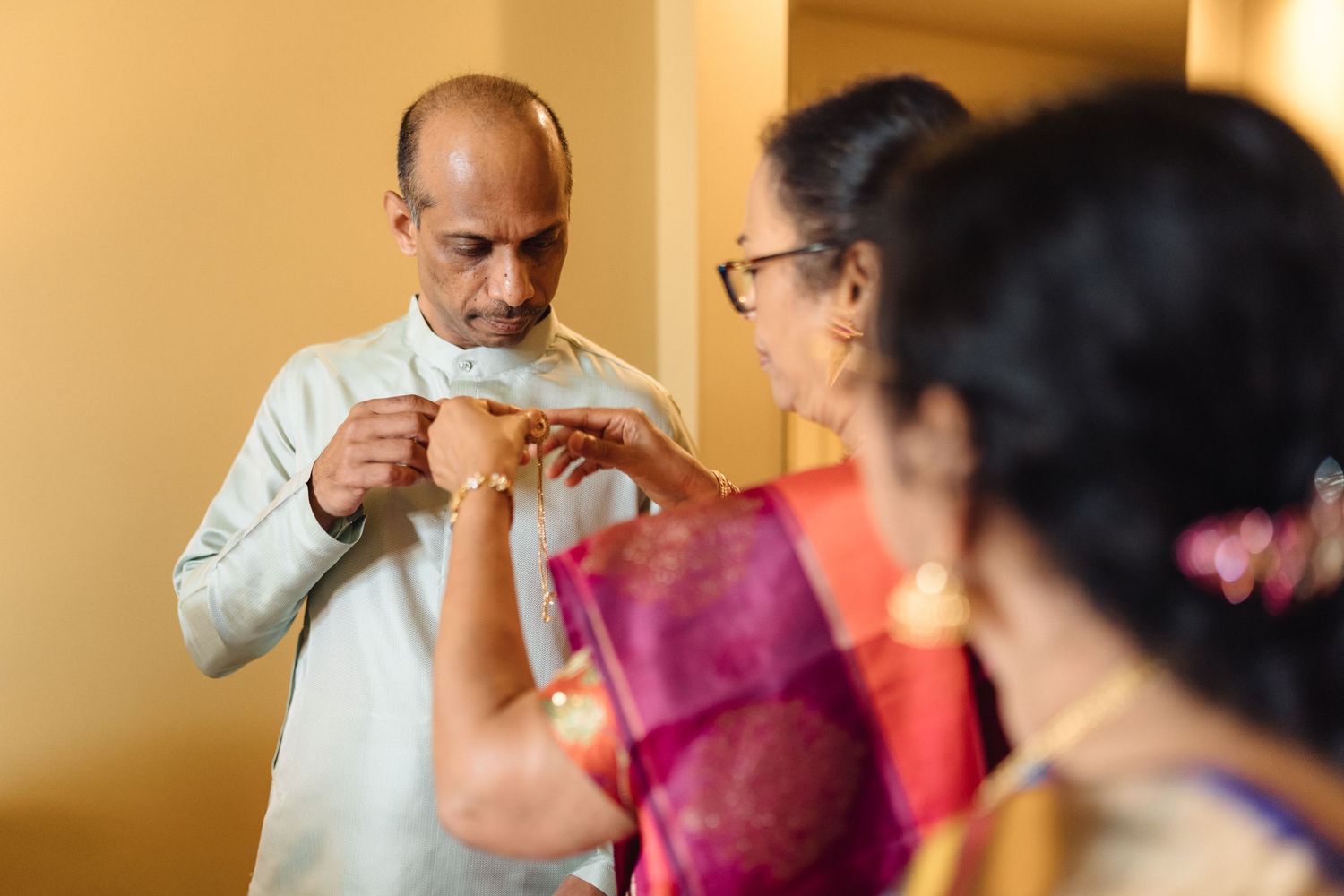 Wedding preparation scene with warm ambient lighting and traditional attire.