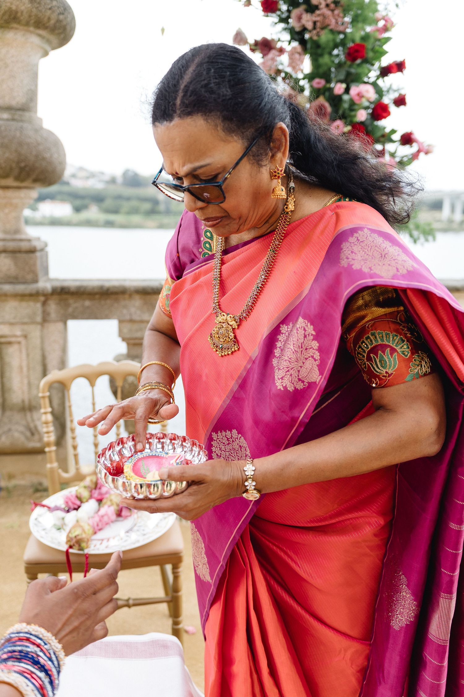 Close-up shots of traditional Indian wedding customs with decorative plates and vibrant attire.