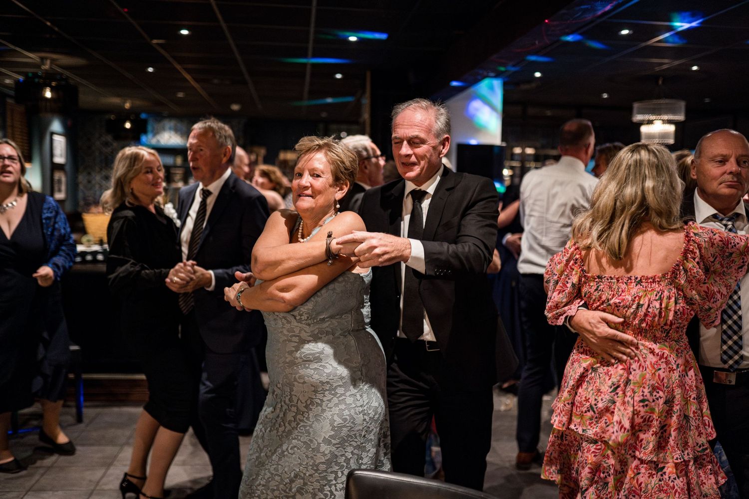 Dance floor scenes from an evening celebration with warm lighting and festive atmosphere.
