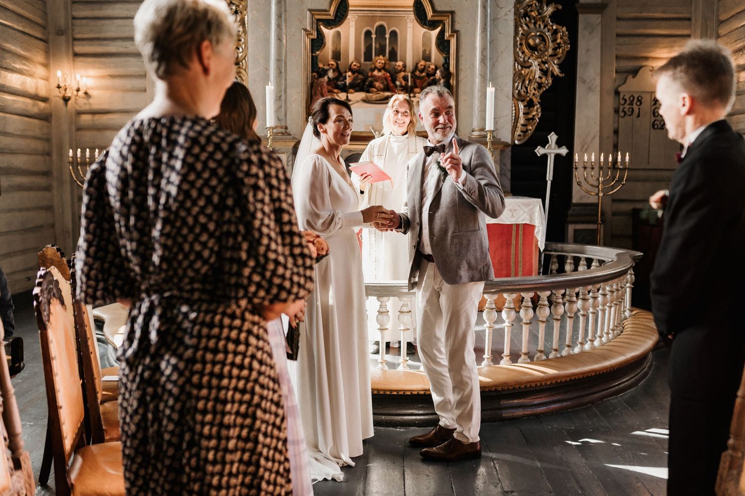 Wedding reception venue with elegant decor and guests mingling in a historic building.