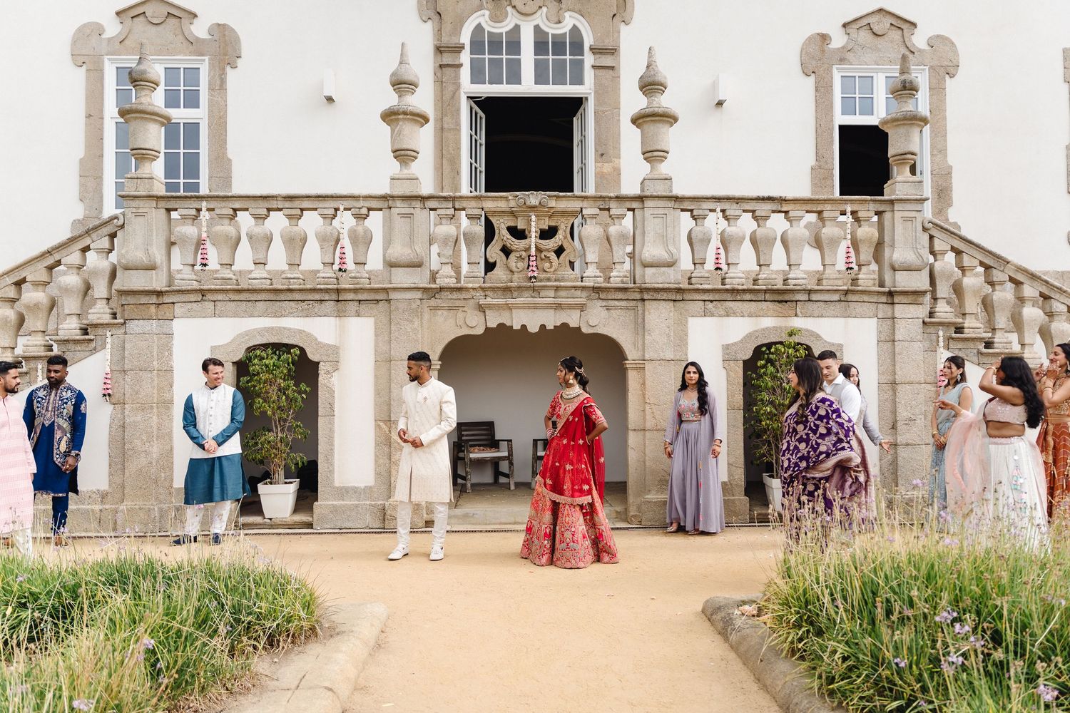 Wide architectural shot of stone balustrade and columns at elegant wedding venue.
