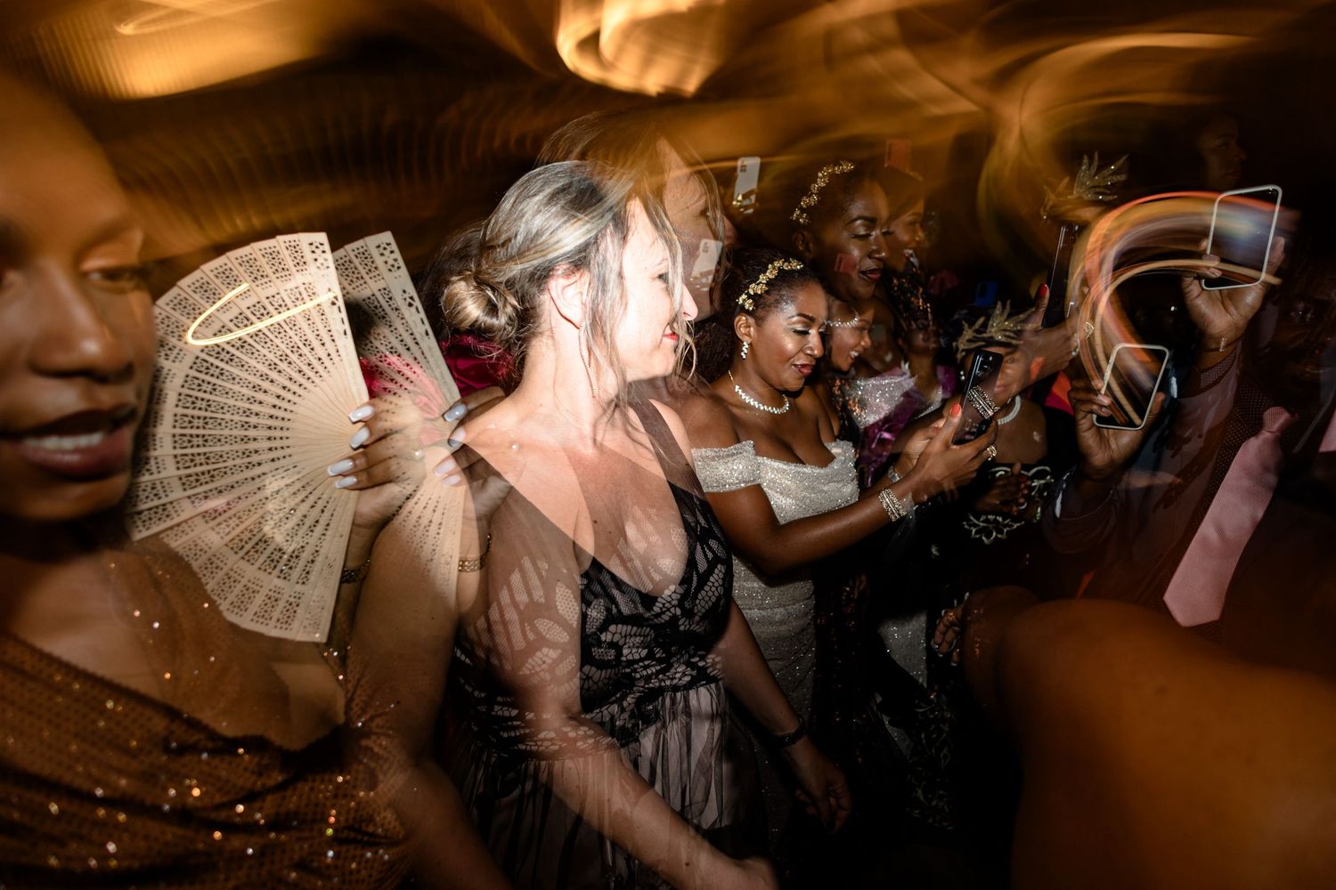 Guests enjoying a lively dance party with dramatic lighting and festive atmosphere.