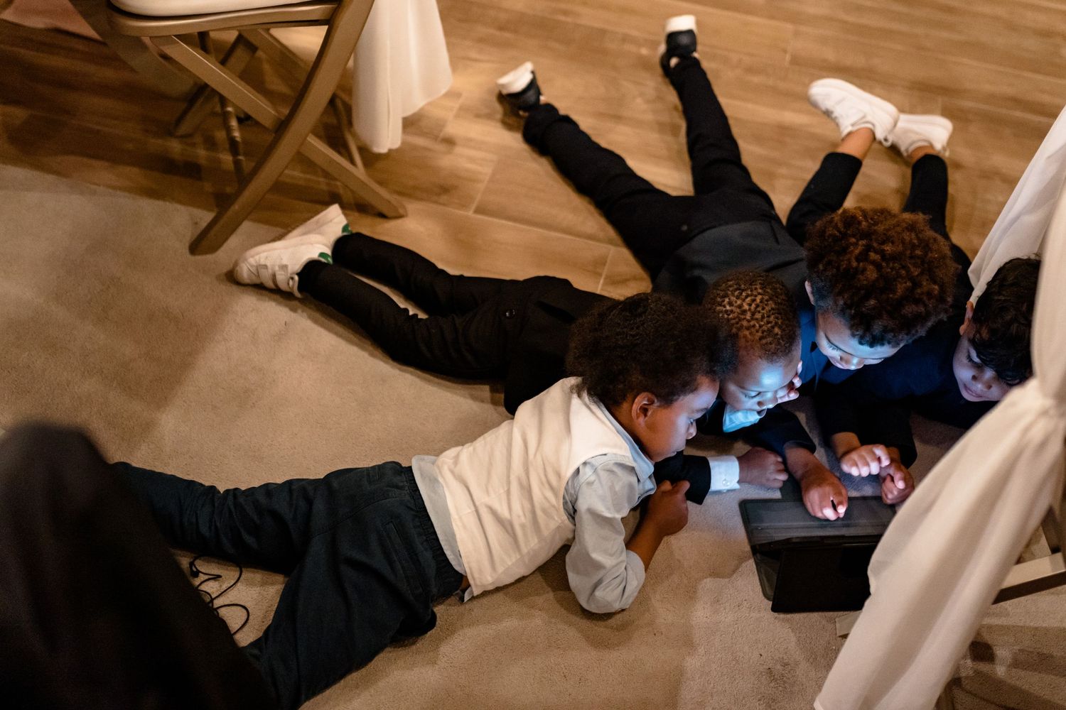 Wedding guests lying on the dance floor during a fun party moment.