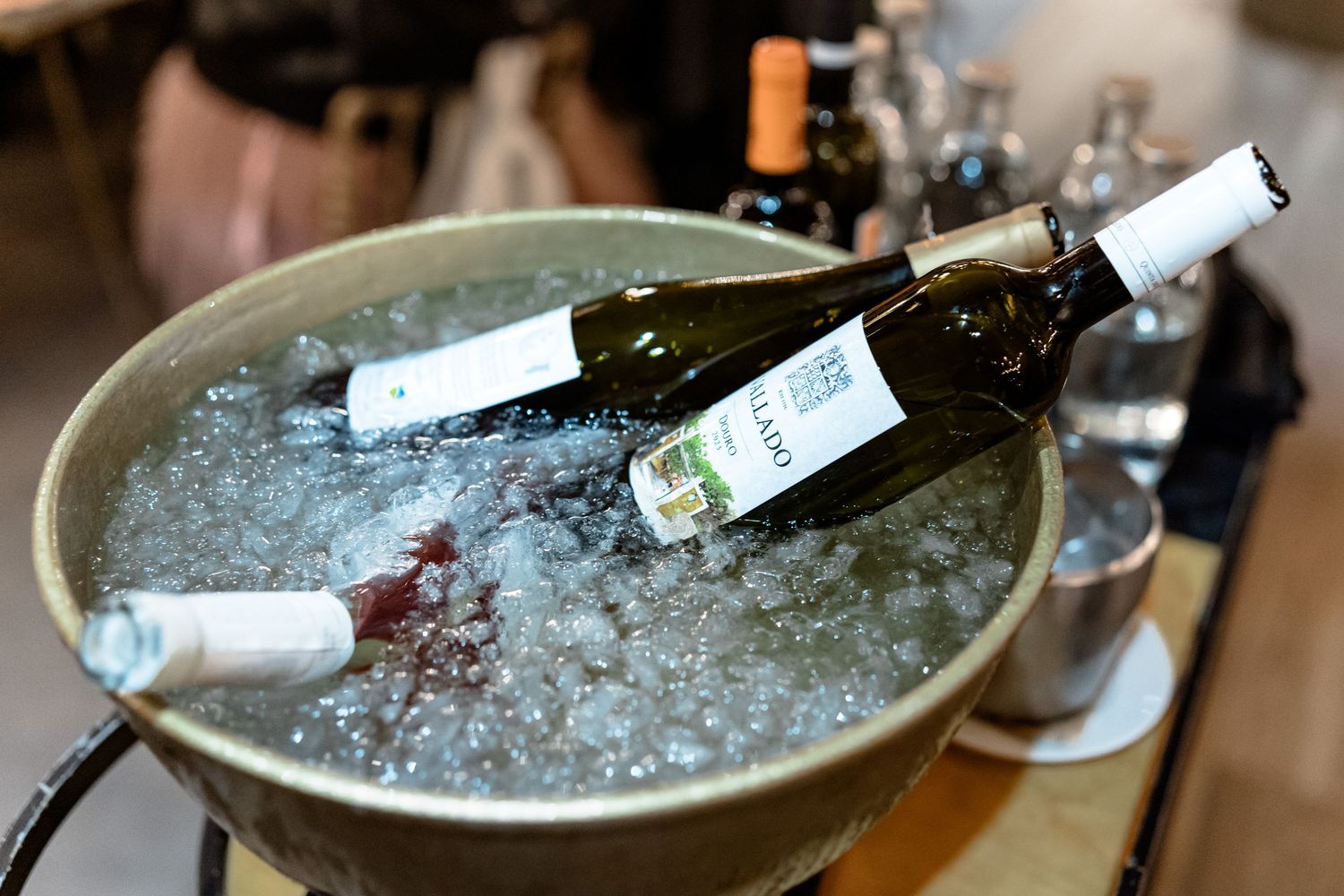 Wine bottles chilling in ice bucket at elegant event.
