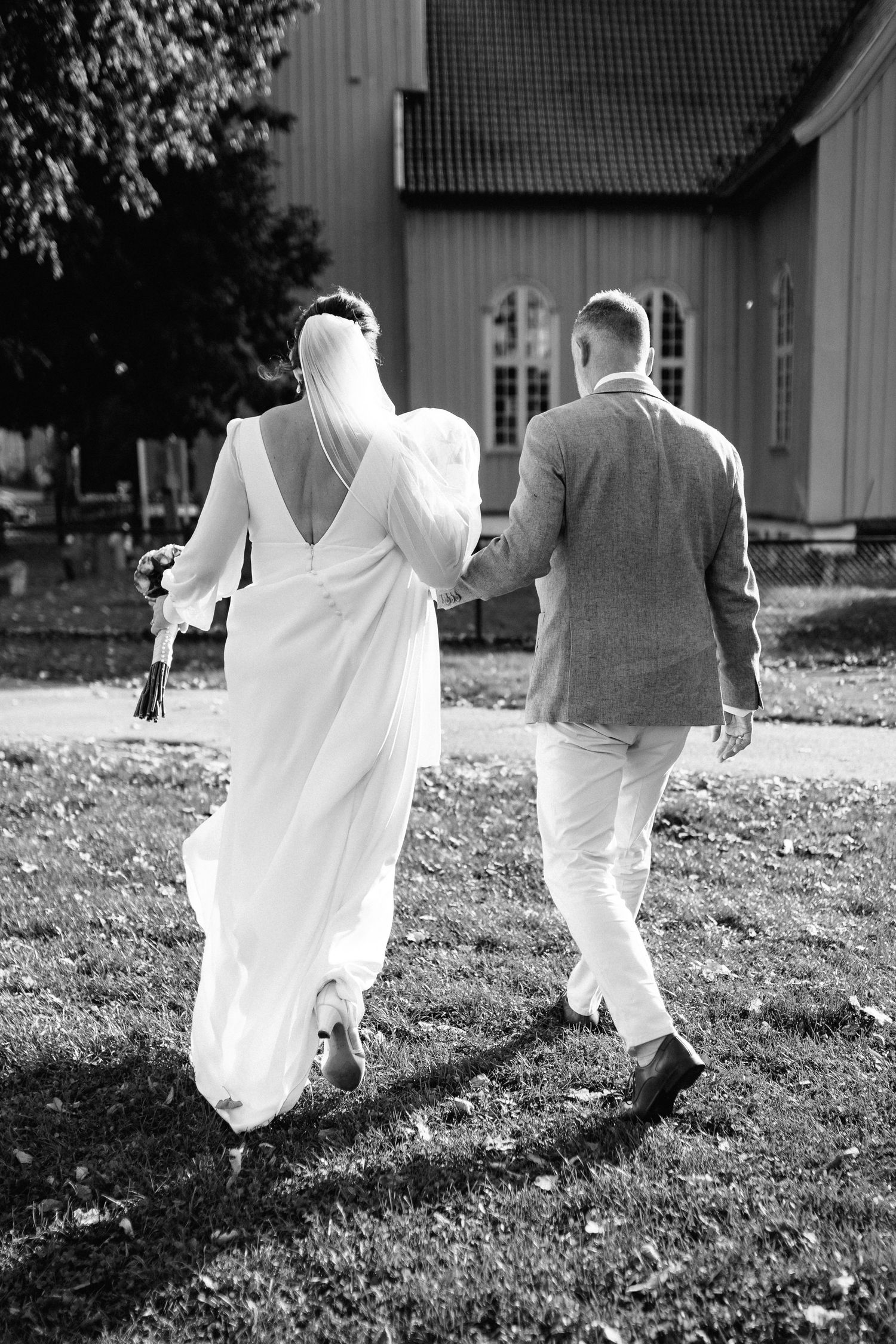 A series of ethereal black and white photos showing people in flowing white dresses walking on grass.