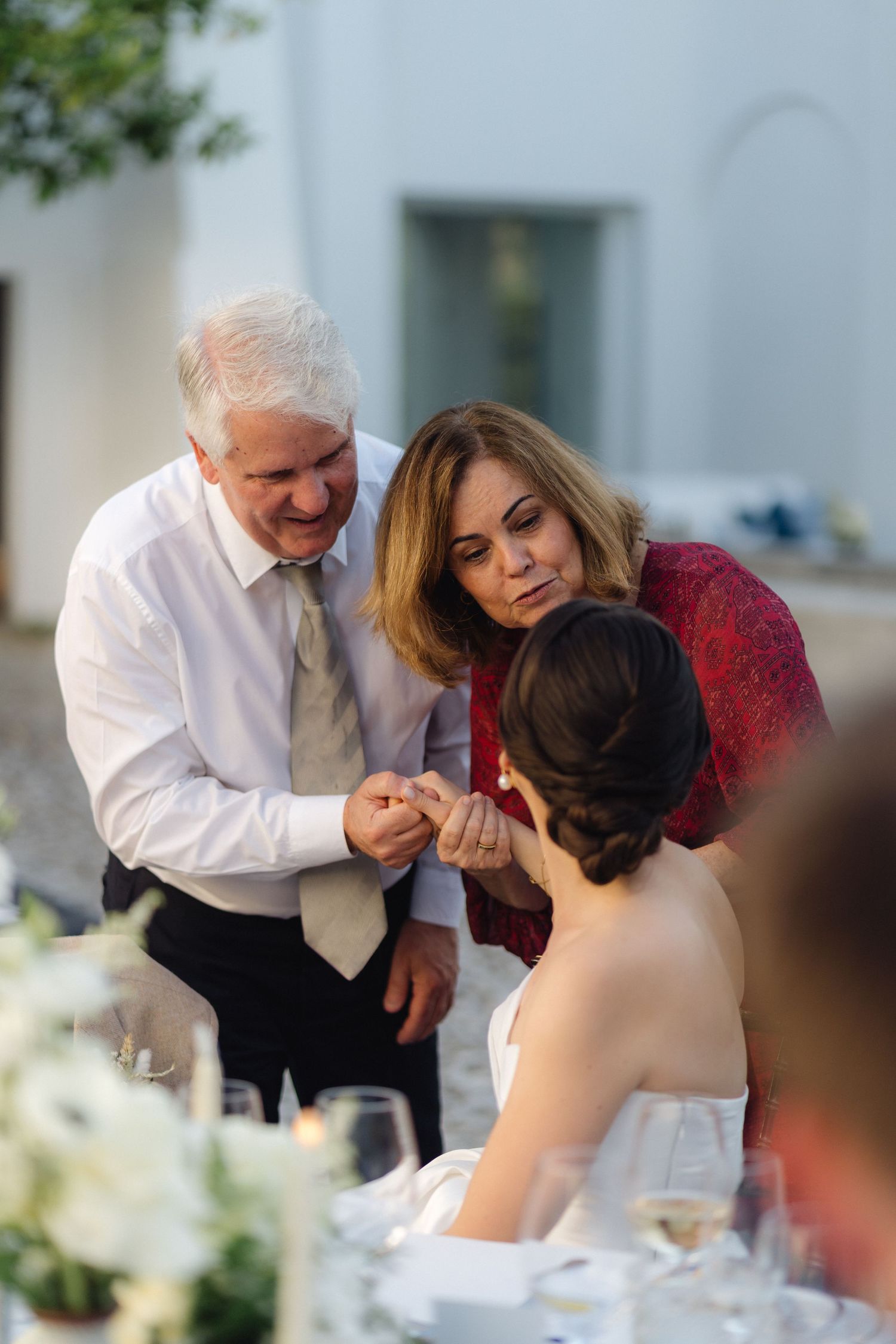 Intimate moments shared between guests during an outdoor wedding reception.