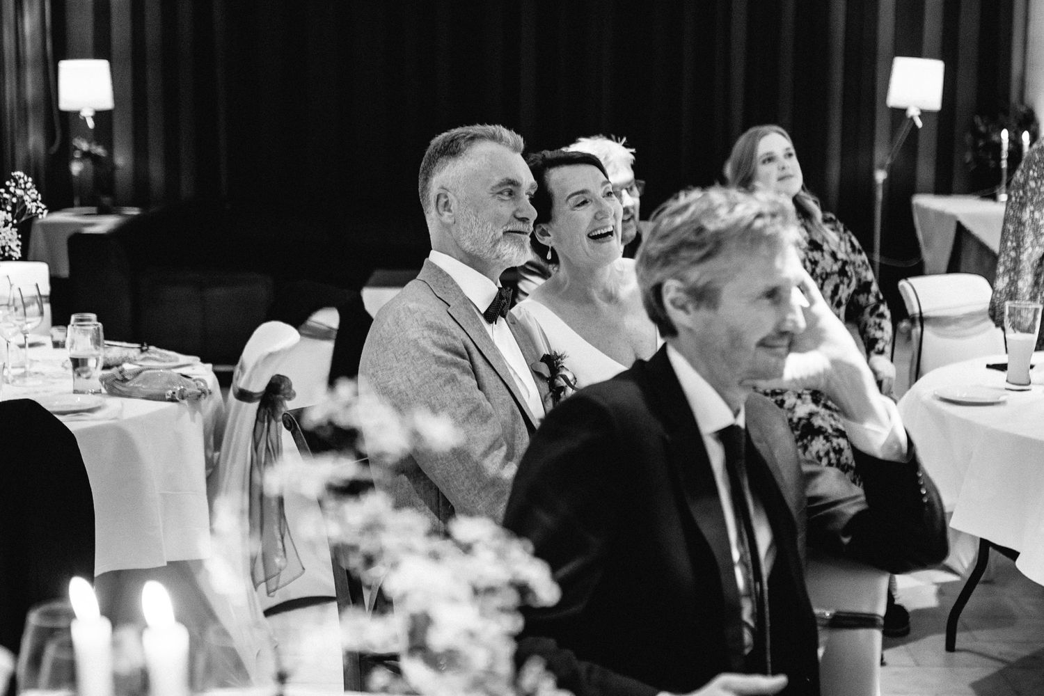 Black and white candid shots of wedding reception celebrations.