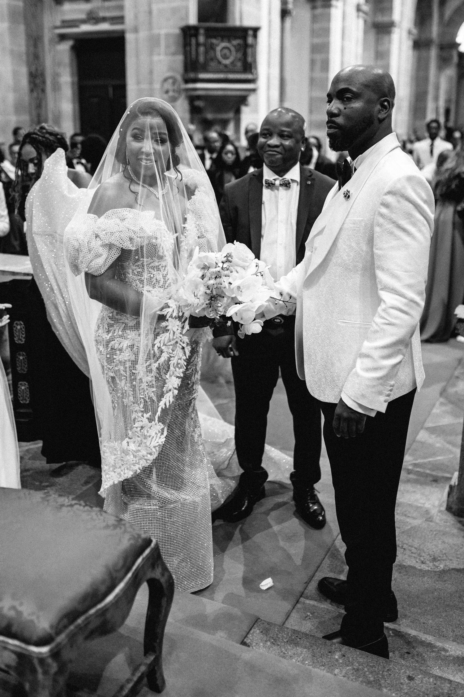 A sequence of black and white wedding photos showing a bride's veil flowing in the wind.