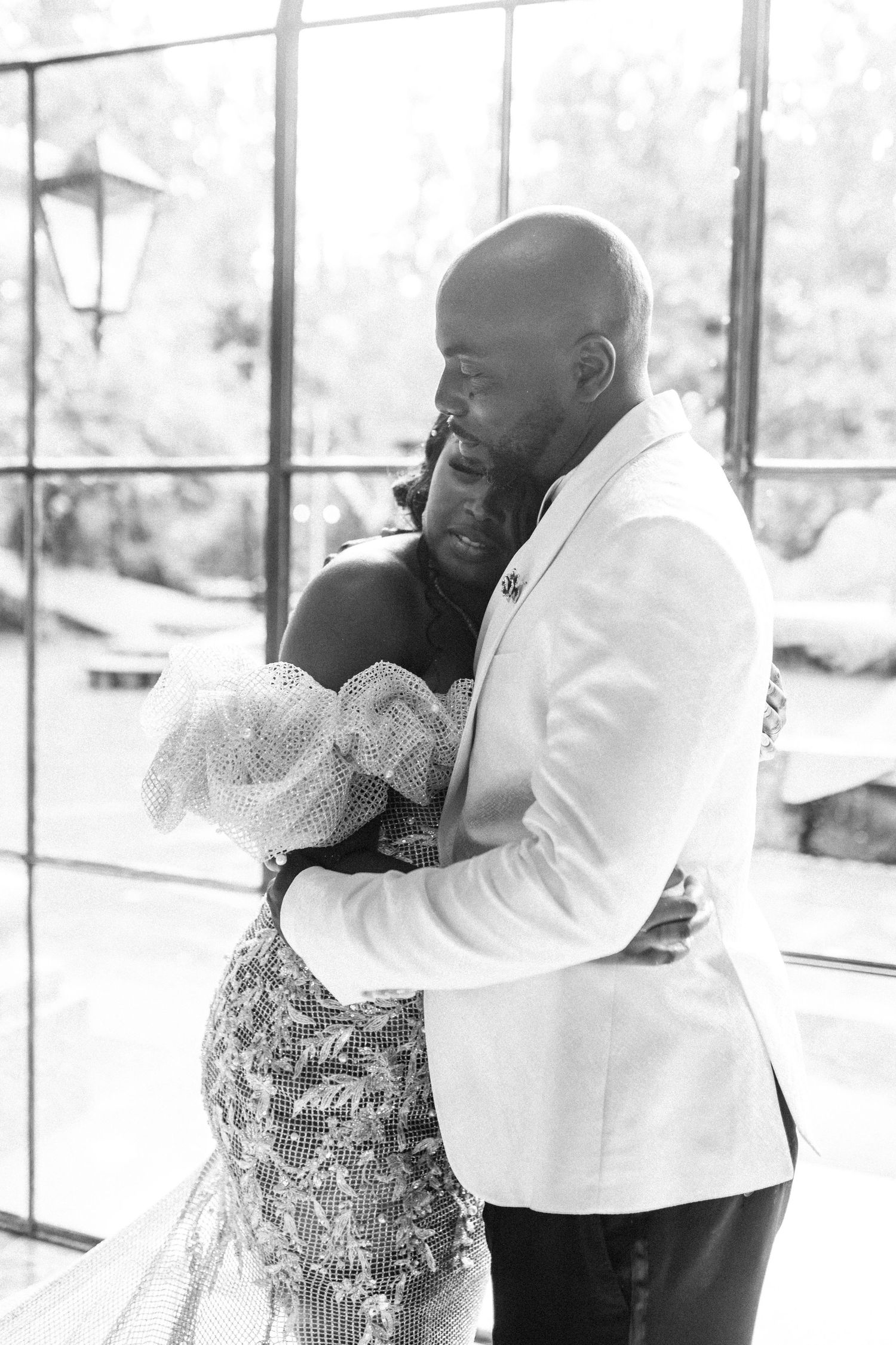 Emotional wedding moment captured in black and white photography.
