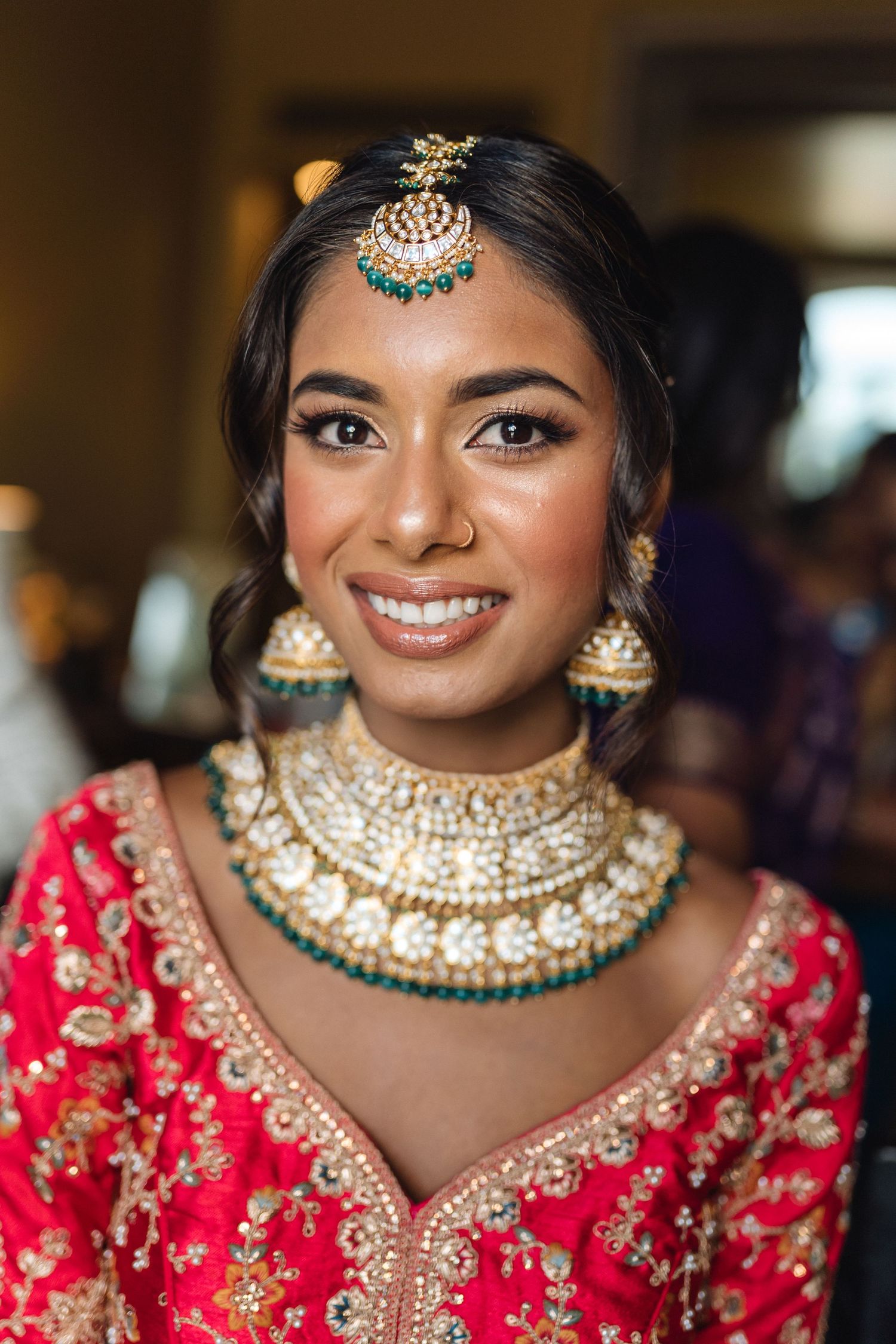 Close-up shots of traditional Indian bridal jewelry and makeup with ornate kundan necklace and turquoise maang tikka.
