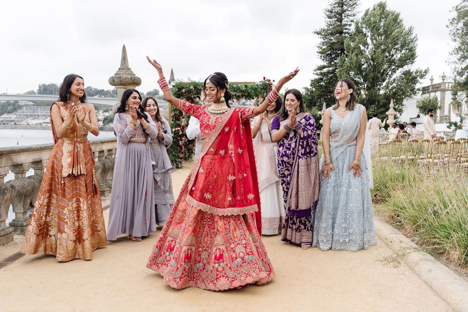 Wedding celebration with guests in colorful traditional attire dancing outdoors.