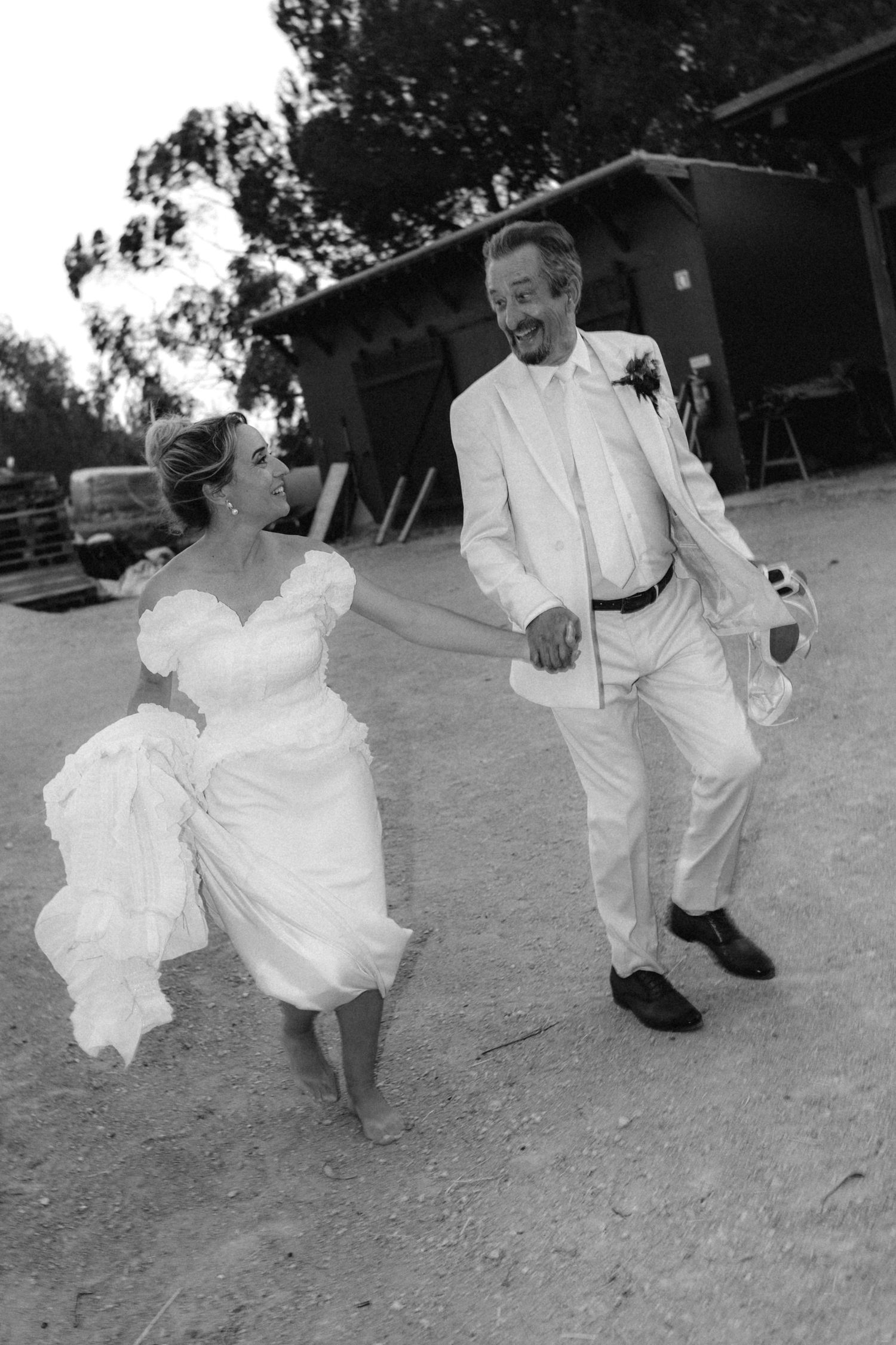 Black and white photos show playful dance moves at an outdoor wedding celebration.
