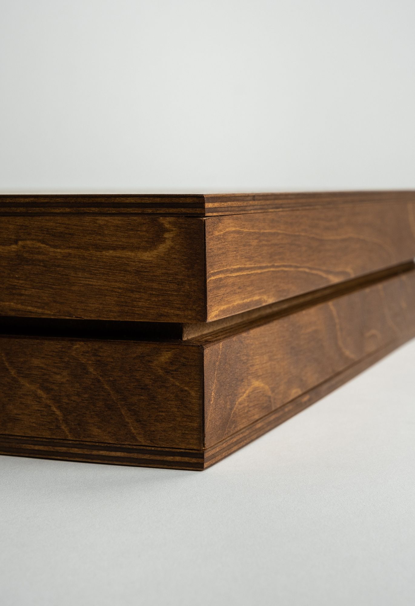 A series of wooden floating shelves shown from different angles displaying their sleek dark stained finish and angled design.
