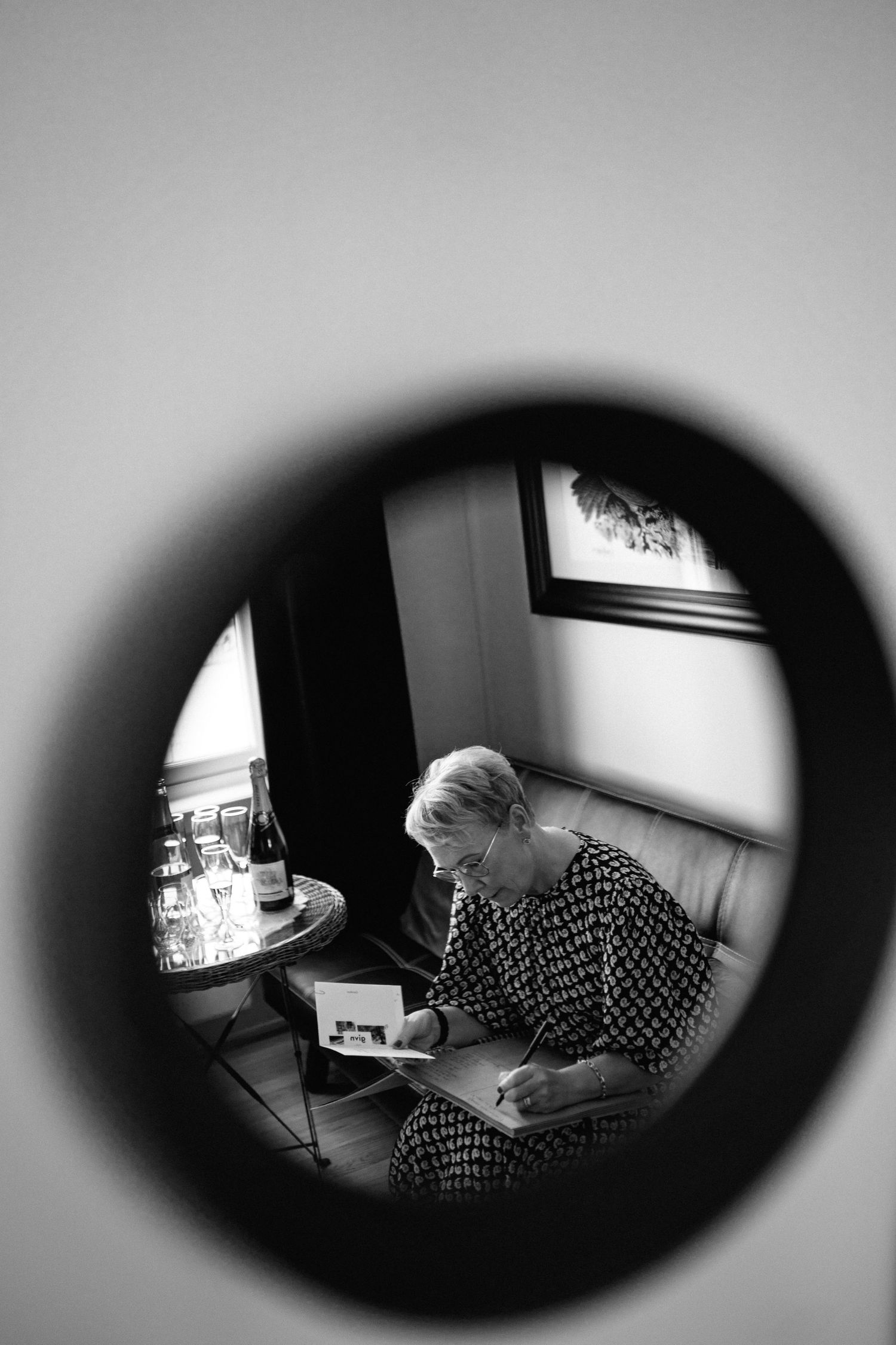 Black and white vignette sequence showing someone working at a desk through a circular frame.