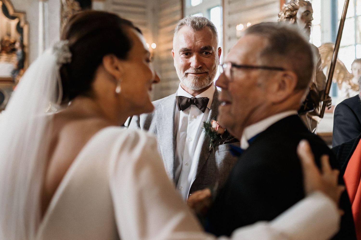 Intimate wedding ceremony moments captured in warm indoor lighting.