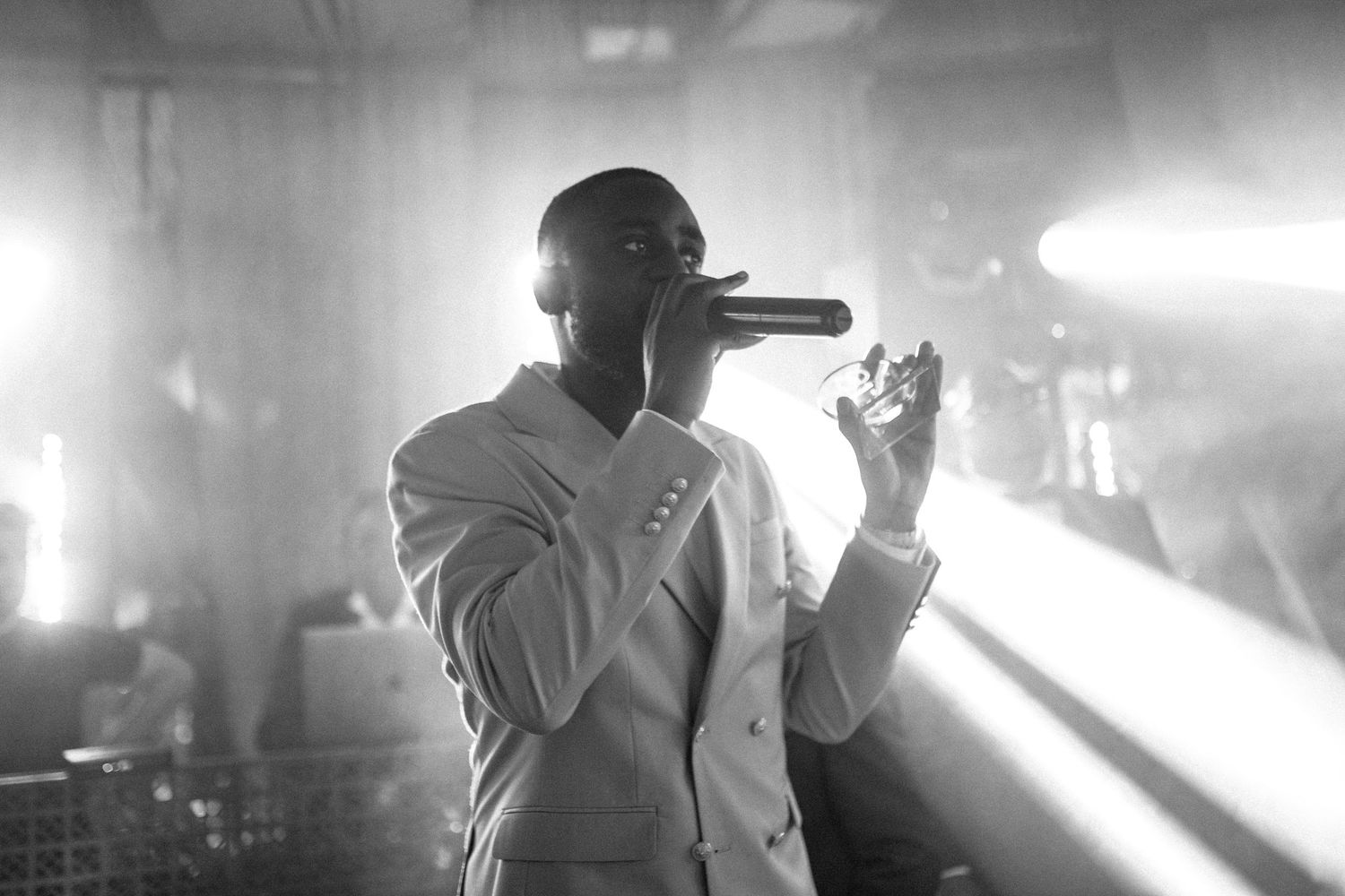 Dramatic black and white photos of performers on stage with atmospheric lighting.
