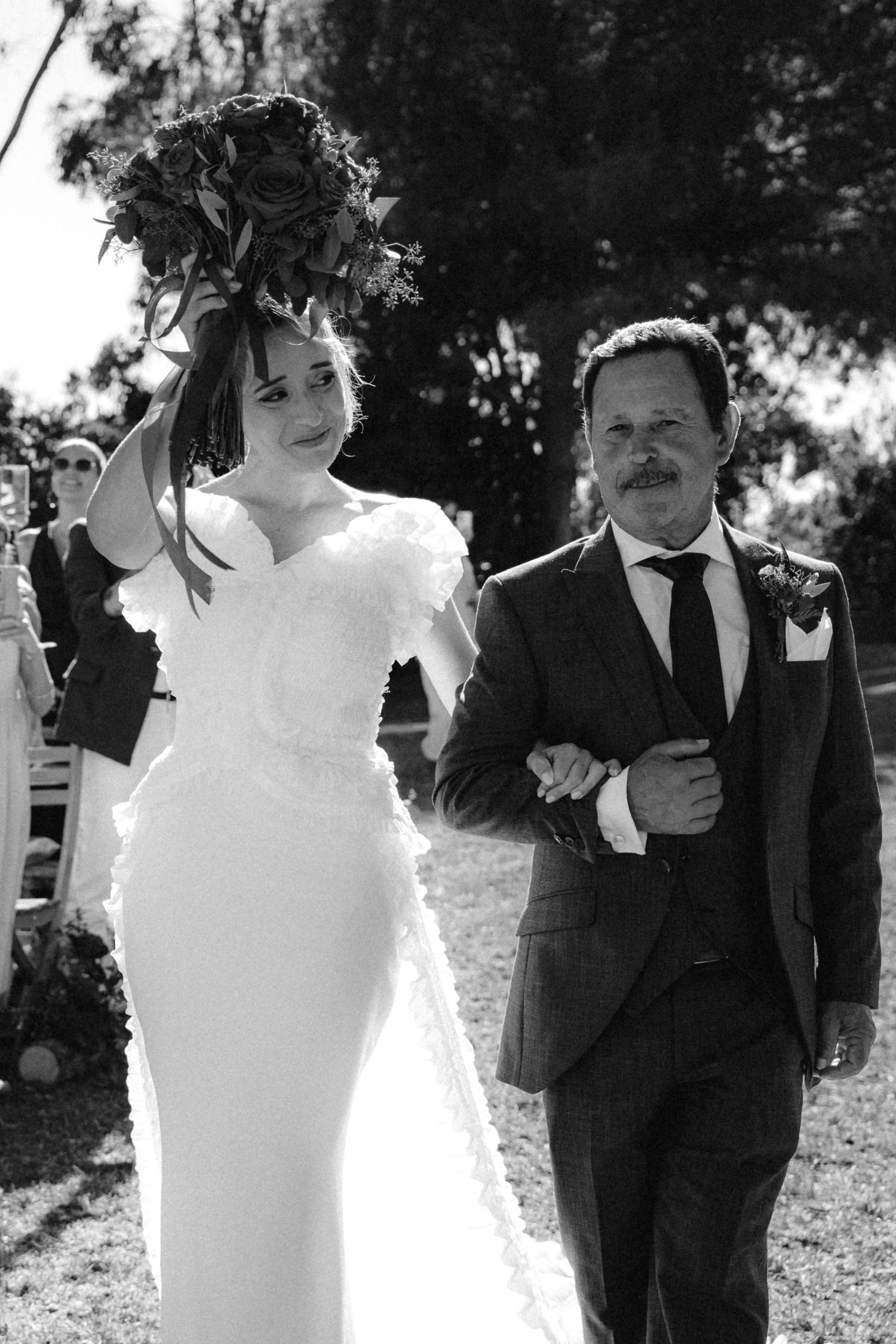 Black and white wedding portraits showing intimate moments between the couple outdoors.