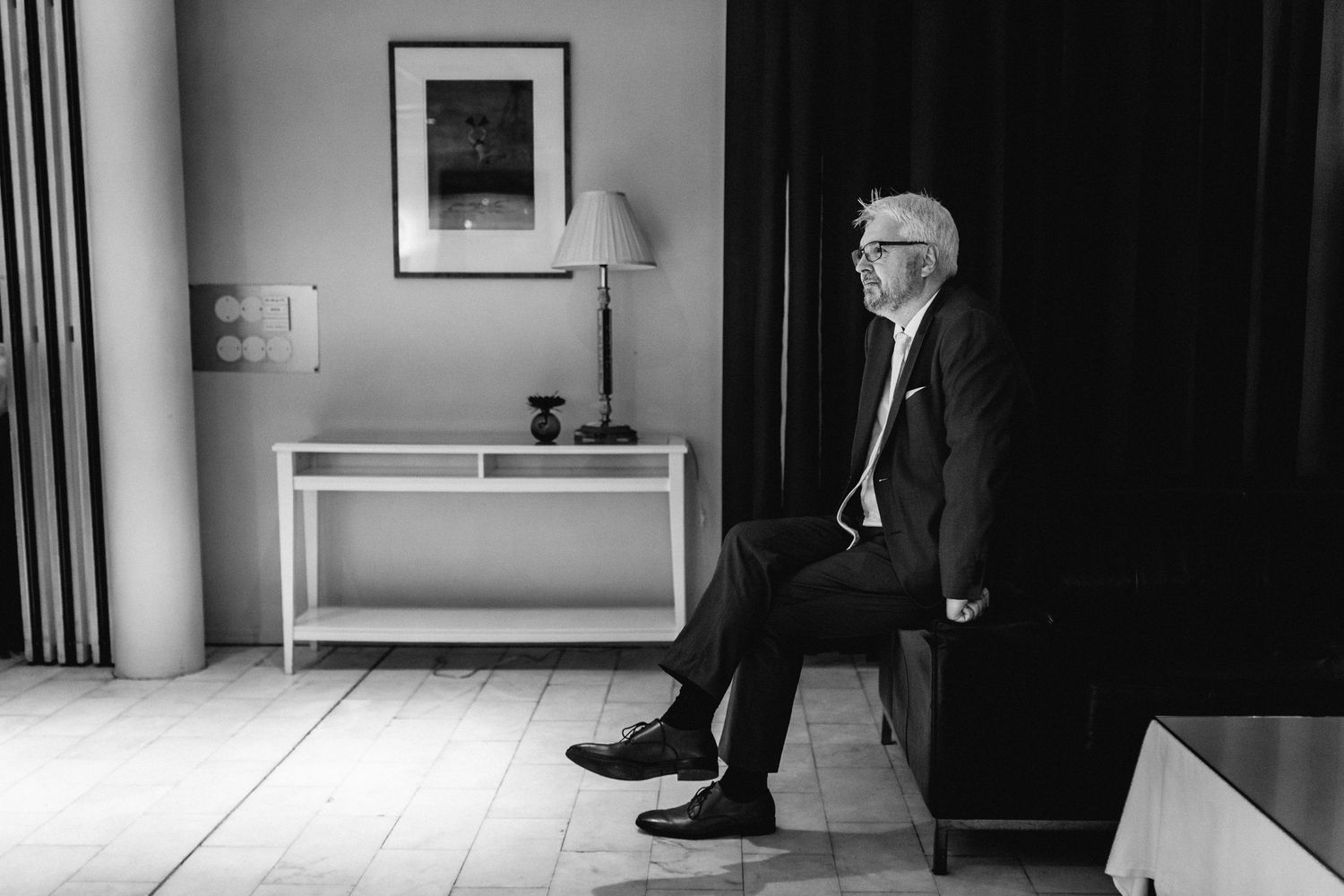 Minimalist black and white composition showing formal shoes and shadows.