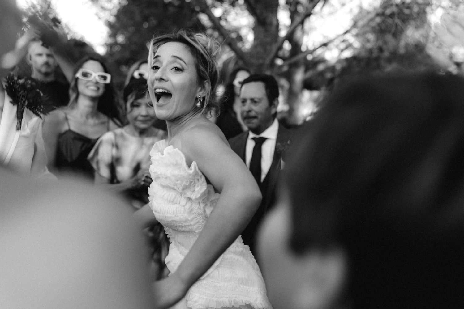 Black and white photos showing emotional reactions during wedding festivities.