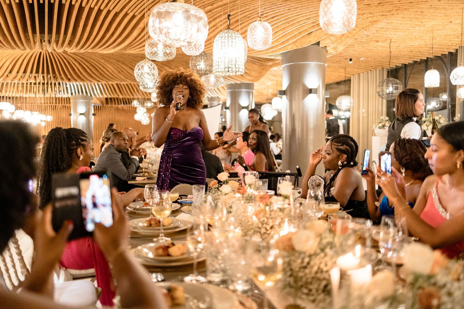 Elegant reception venue with warm lighting and crystal chandeliers creating a romantic atmosphere.