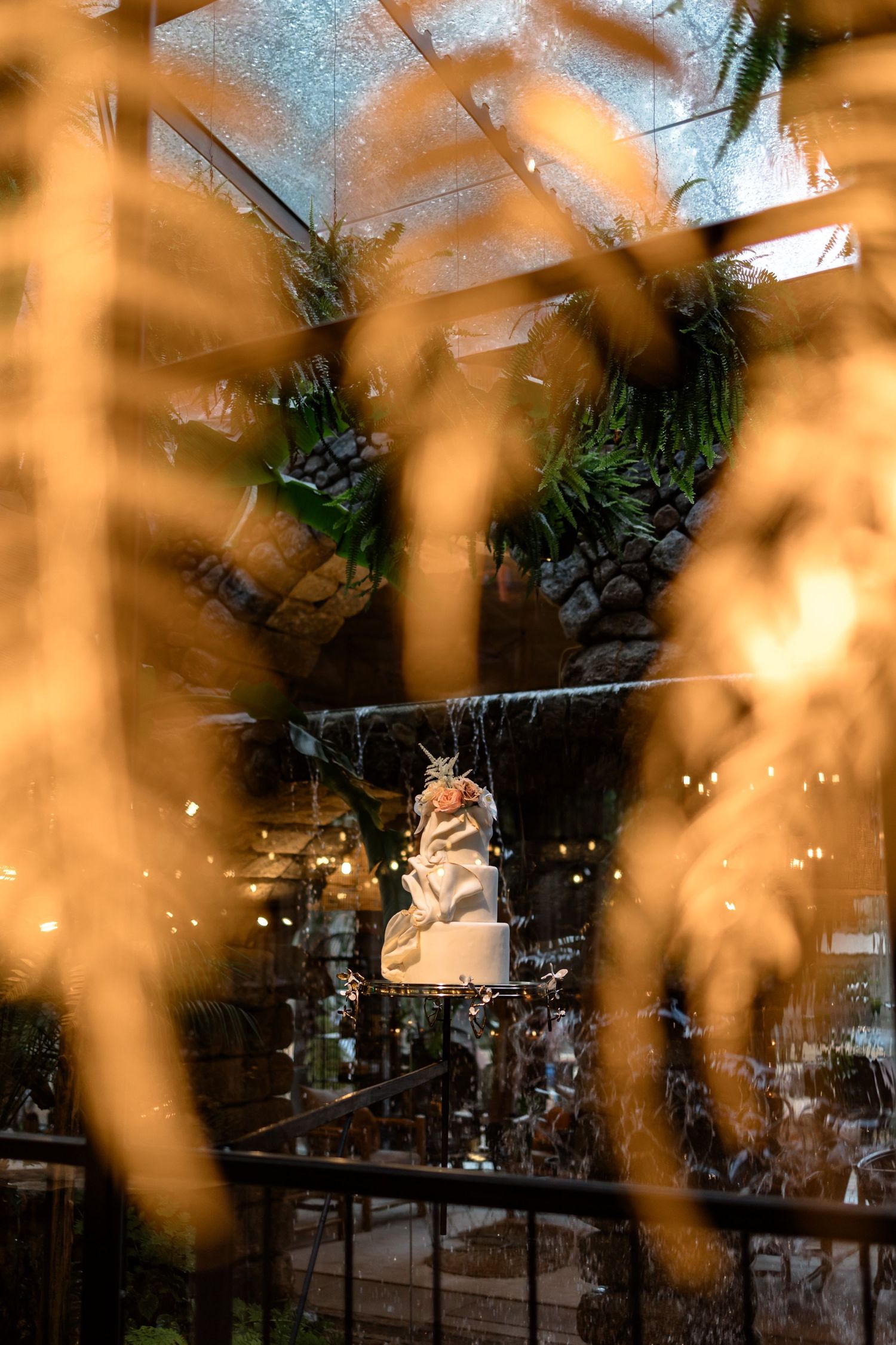 Romantic wedding venue with twinkling lights and warm amber glow creating a dreamy atmosphere.