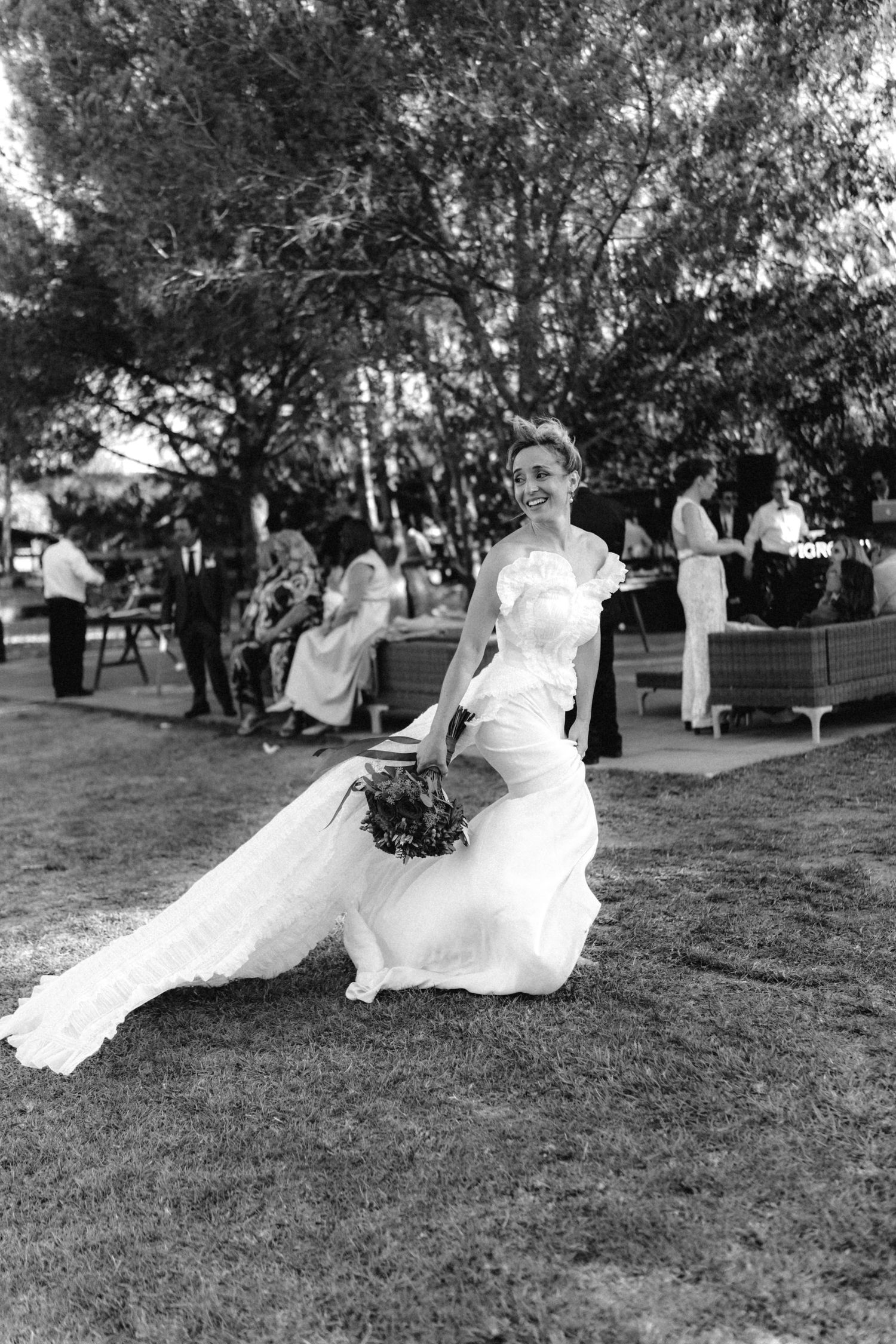 Black and white sequence of a person sitting on grass in formal attire.