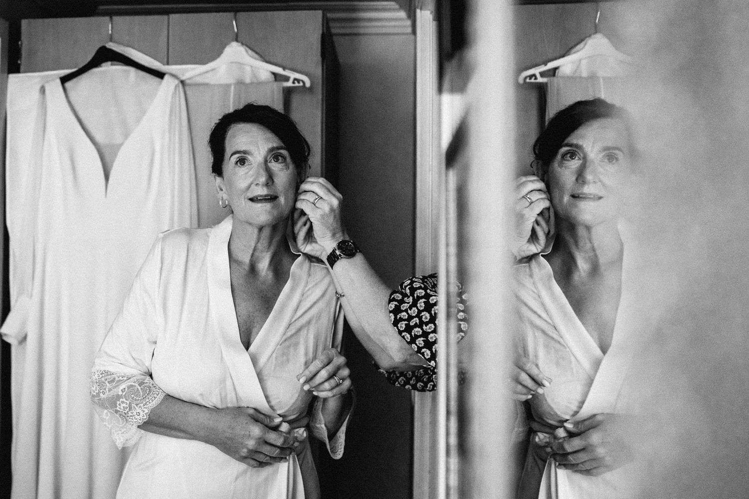 A series of black and white photographs showing someone in white clothing getting ready for a special occasion.