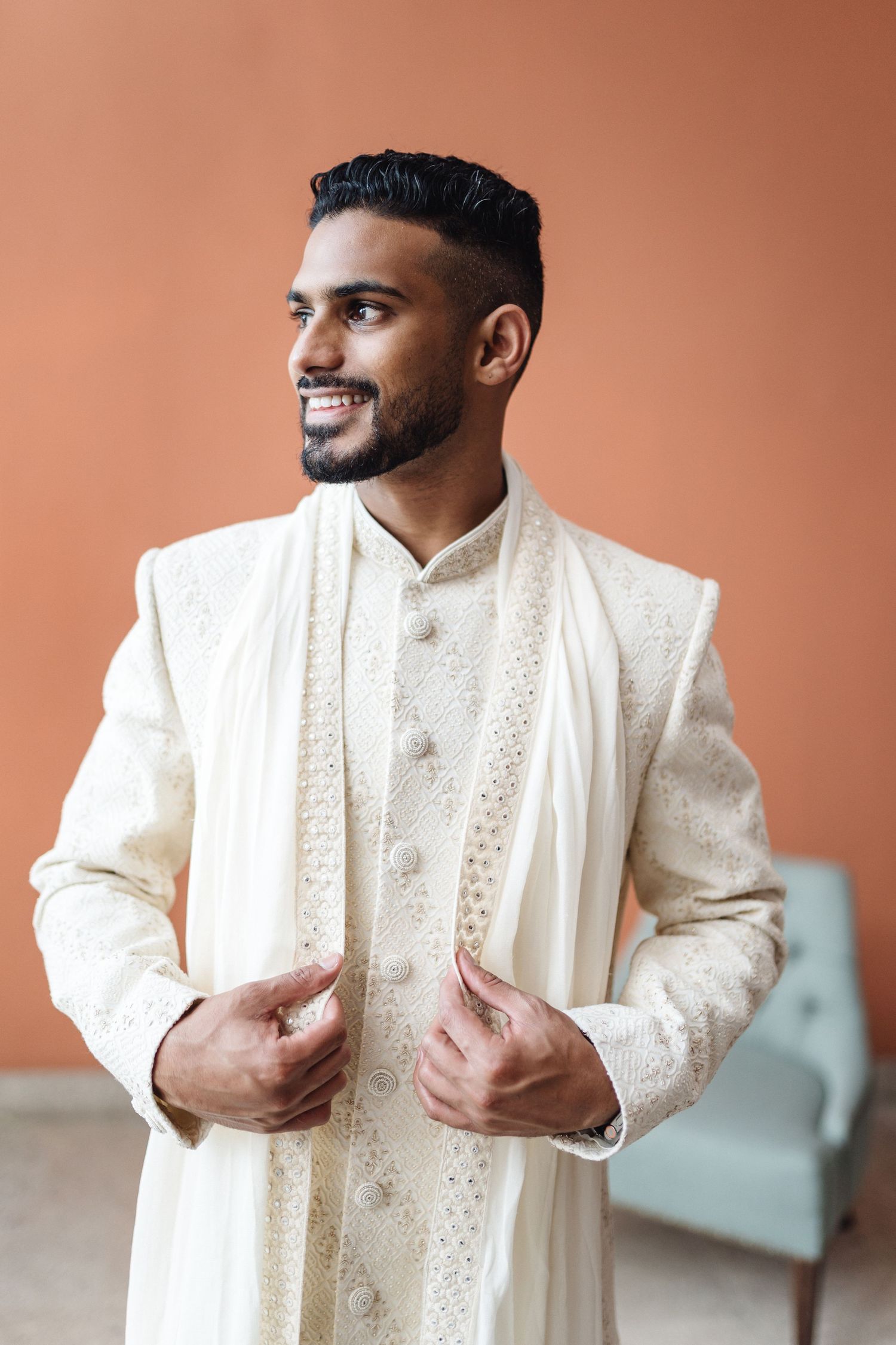 Traditional white sherwani with intricate embroidery details shown from different angles.
