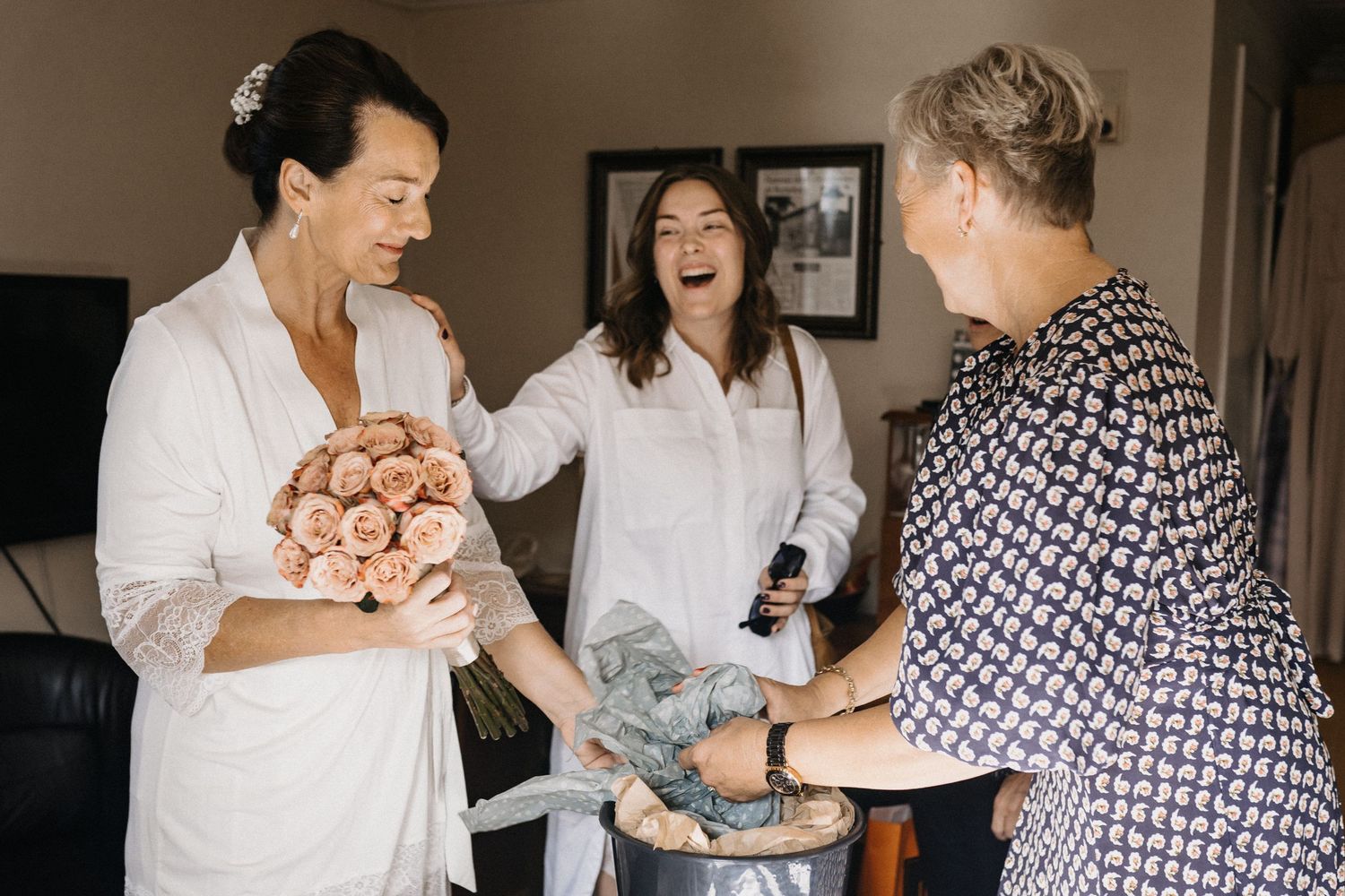 Group of people sharing joyful moments together in casual indoor setting.
