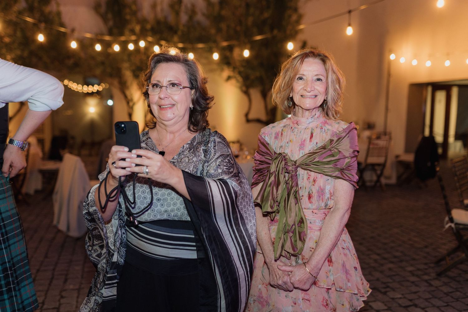 Wedding guests enjoying themselves during an evening reception celebration.