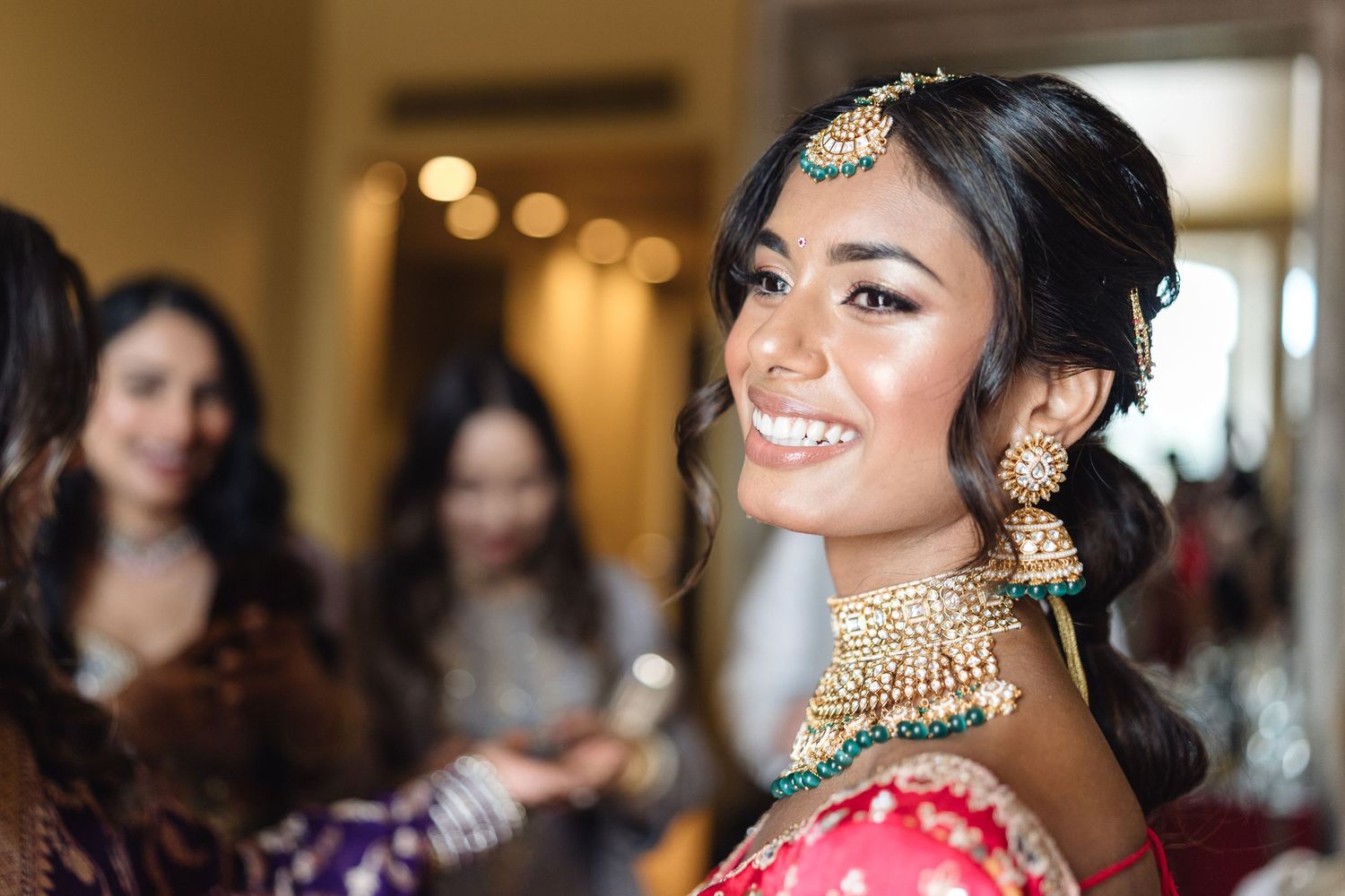 Elegant Indian wedding preparation scene with traditional jewelry and formal attire.