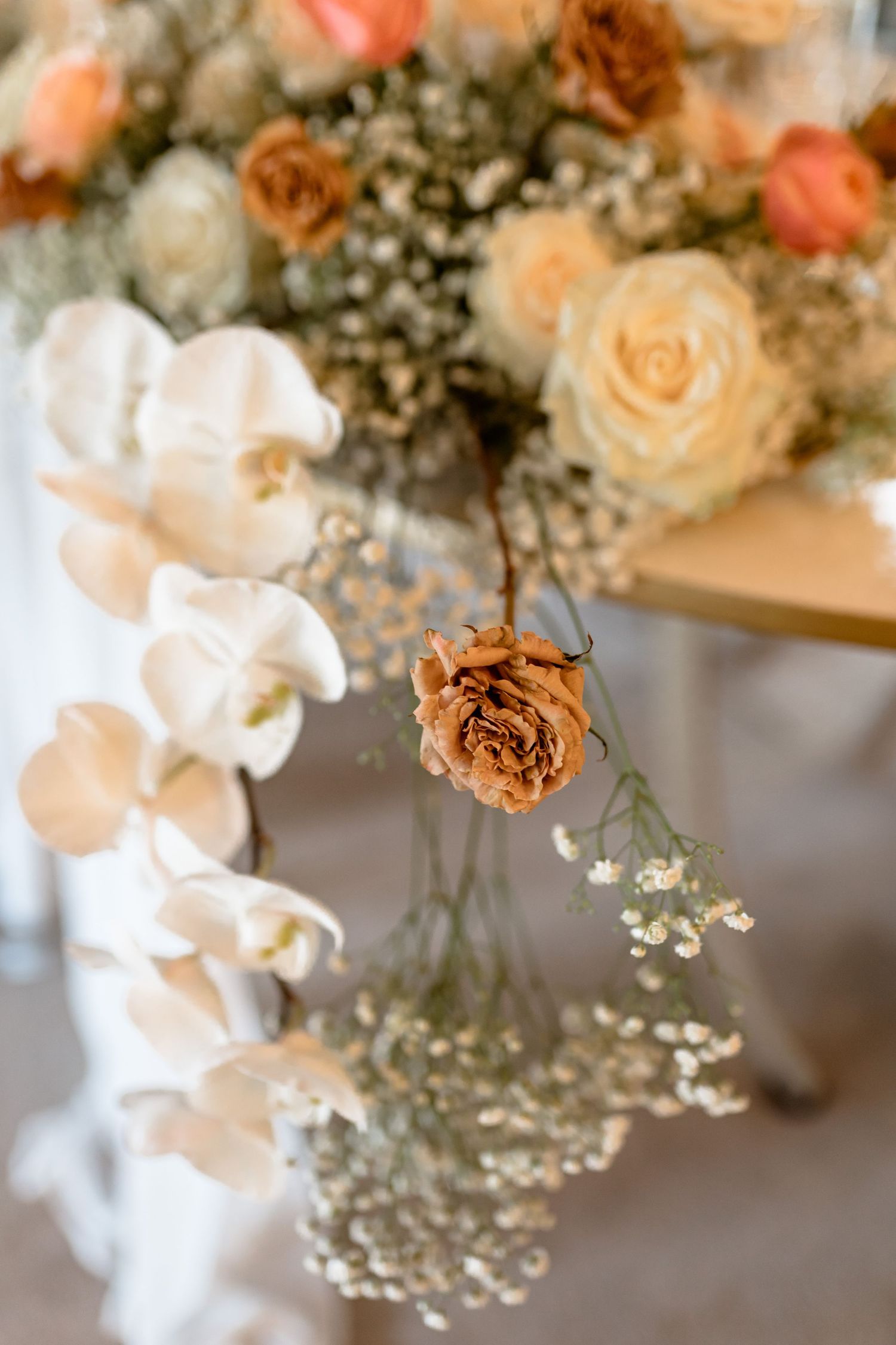 Romantic wedding floral arrangement with peach roses and baby's breath.