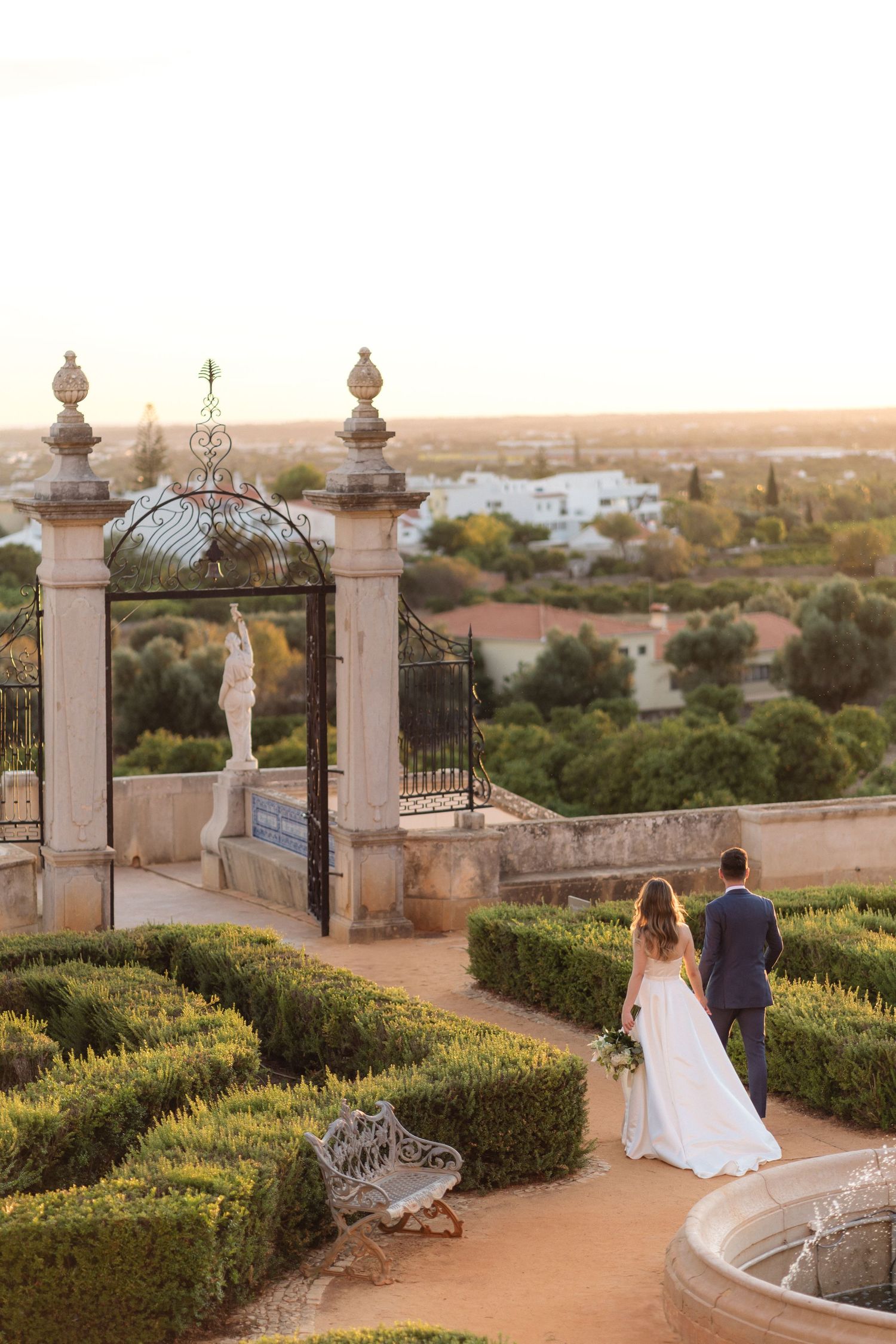 Wedding photography sequence in manicured garden with ornate gates and pillars at sunset.