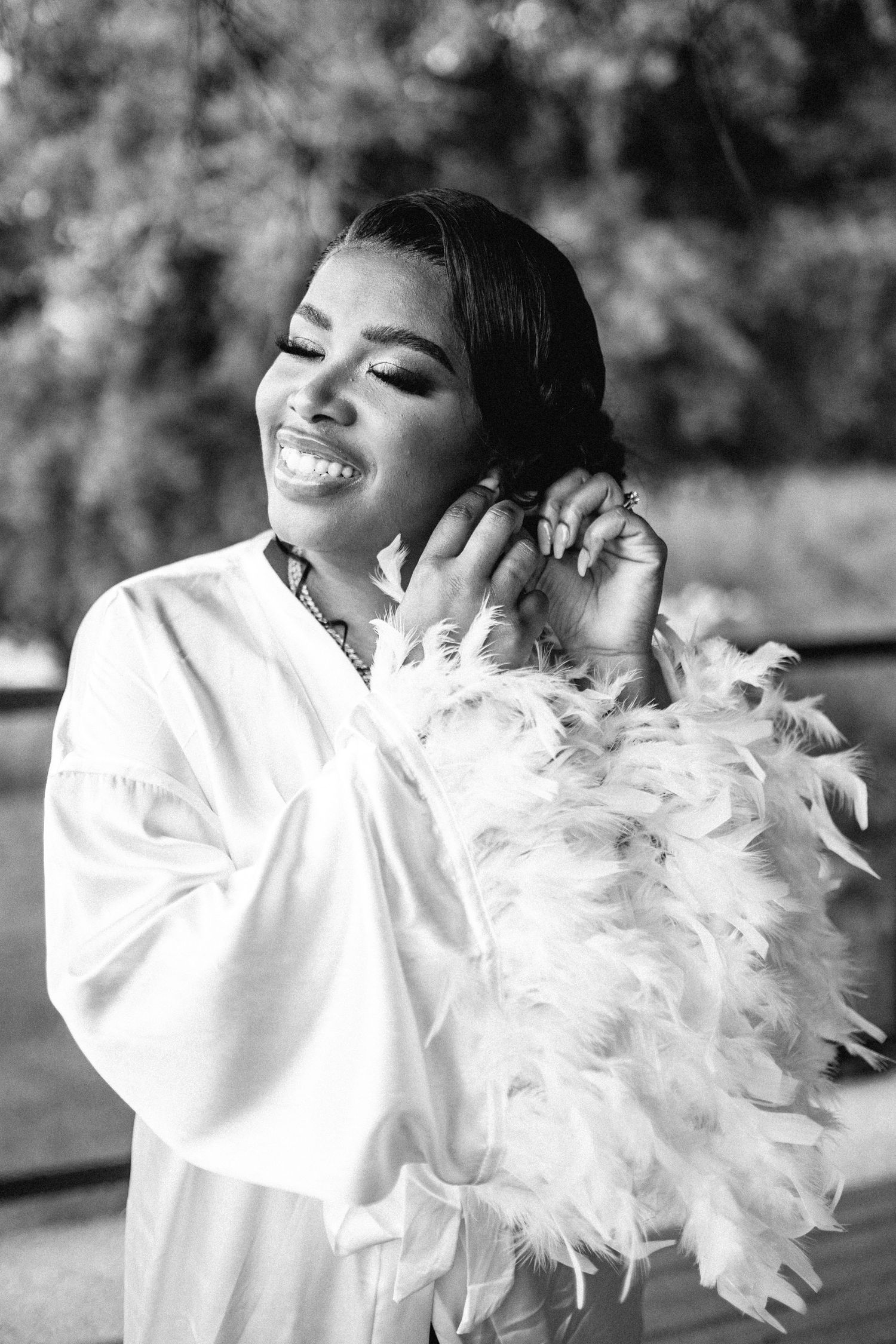 Artistic black and white portraits featuring white feather accessories and elegant styling.