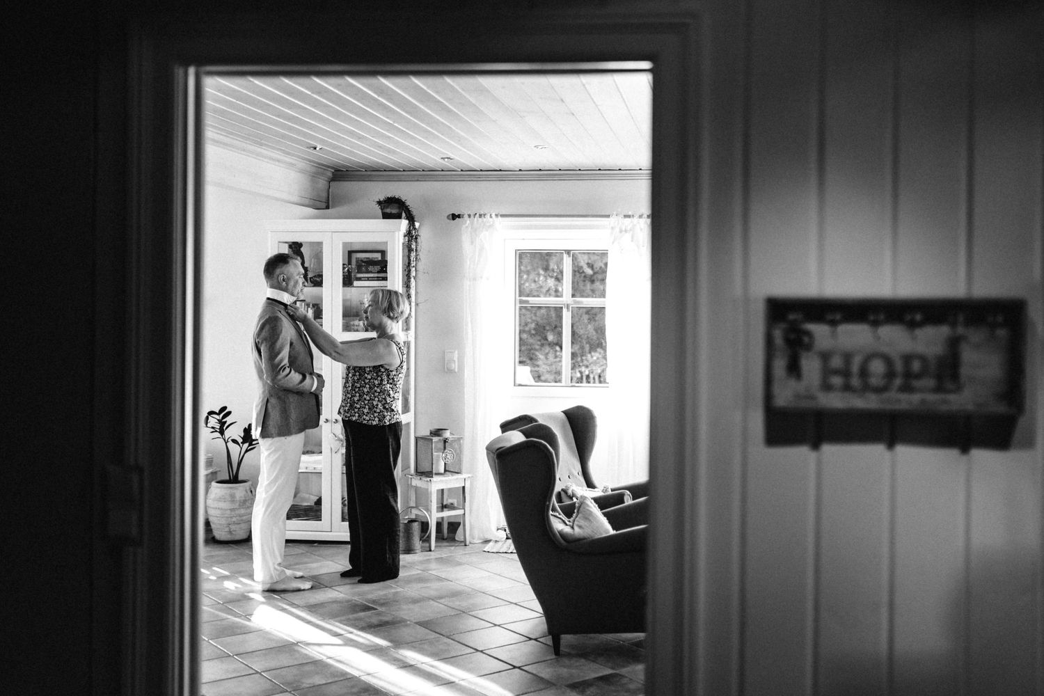 A series of black and white photographs showing interior rooms and hallways with dramatic lighting and shadows.