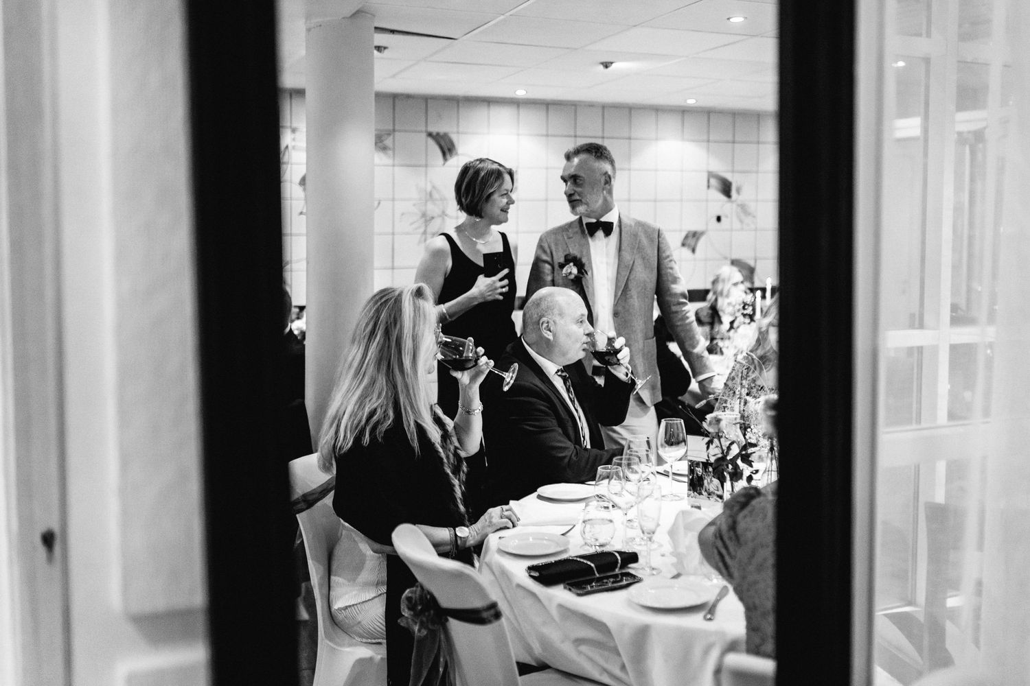 Black and white photos of guests socializing at an elegant indoor event.